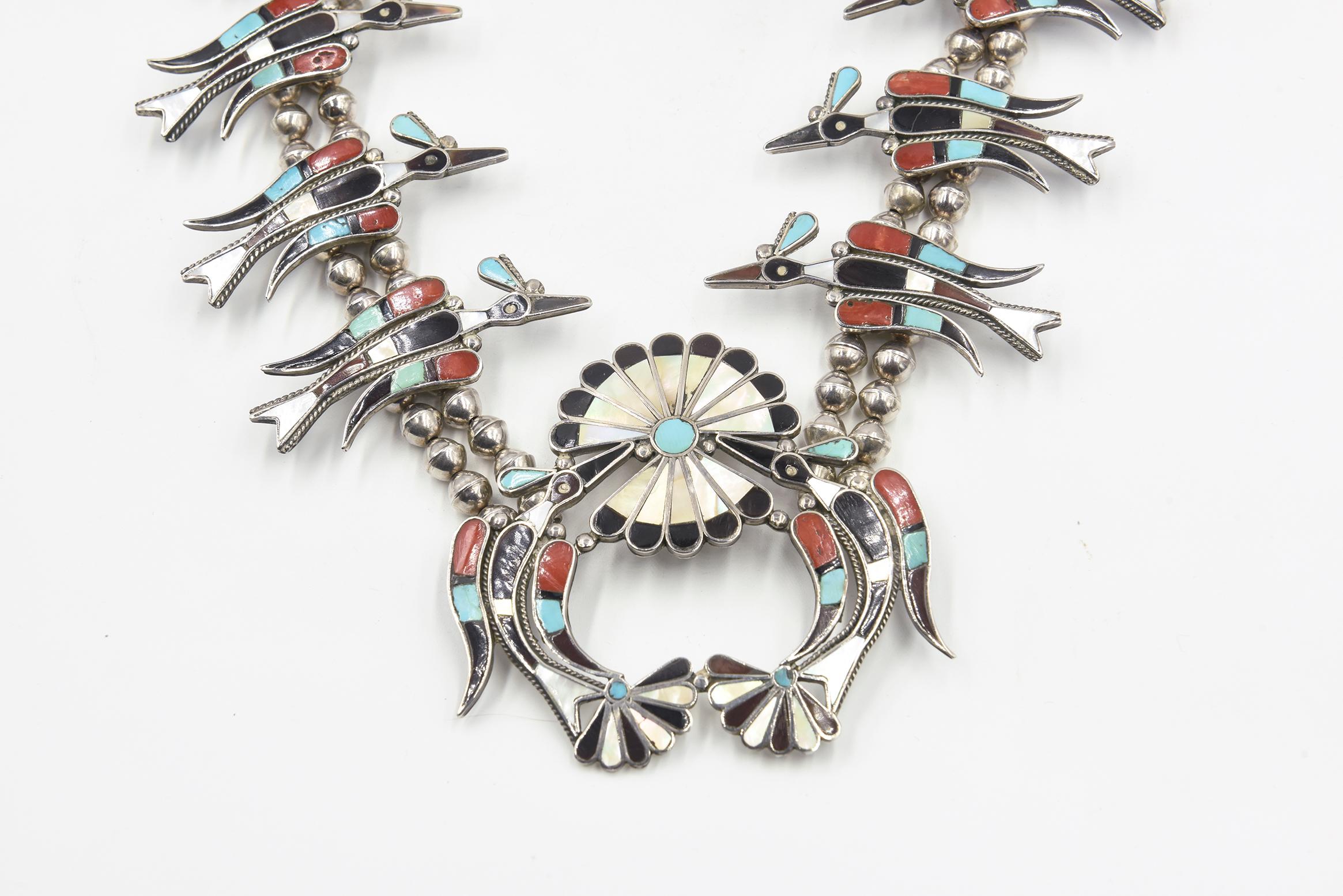 This exquisite Vera Luna Peyote sterling silver squash blossom necklace features 12 peyote bird 