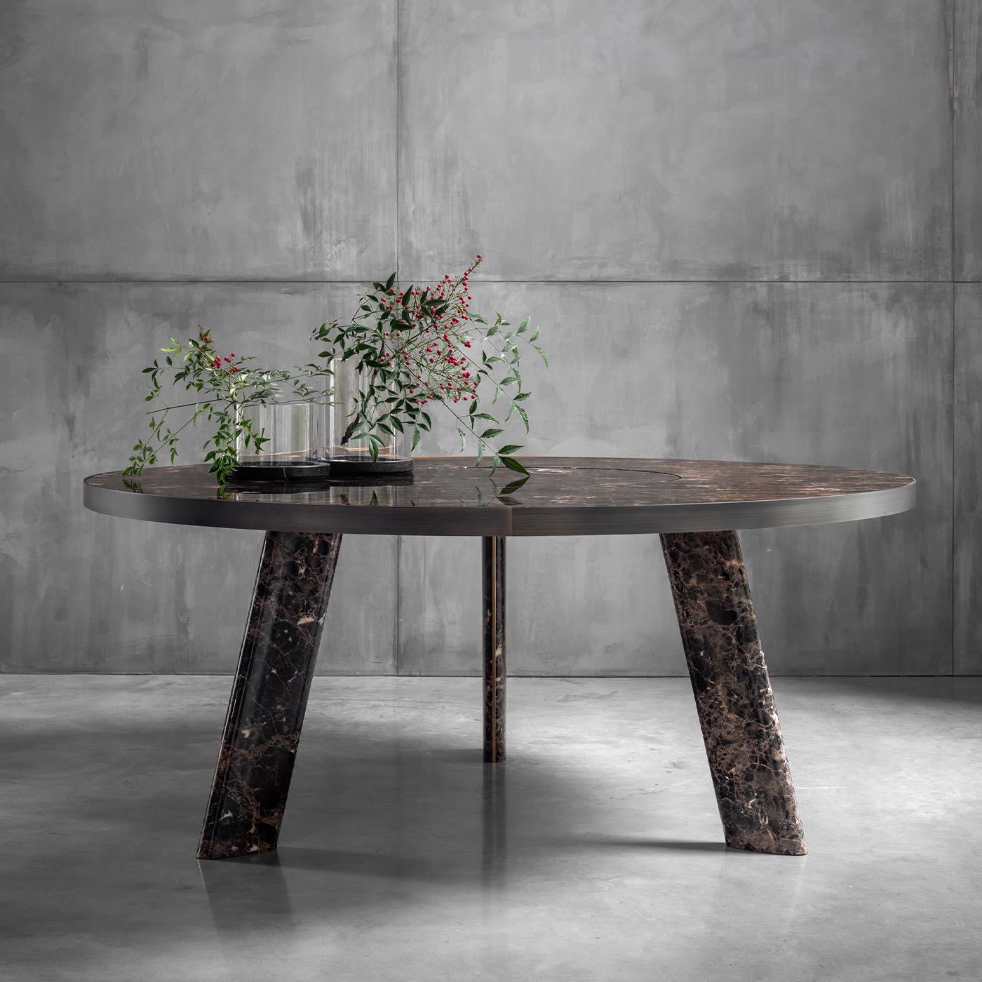 Designed as a balanced synthesis between clean modern lines and the instinctive luxury immediately conveyed by prized Dark Emperador marble, this round dining table will seduce with its intricate, unrepeatable tracery in intense warm tones. The bold