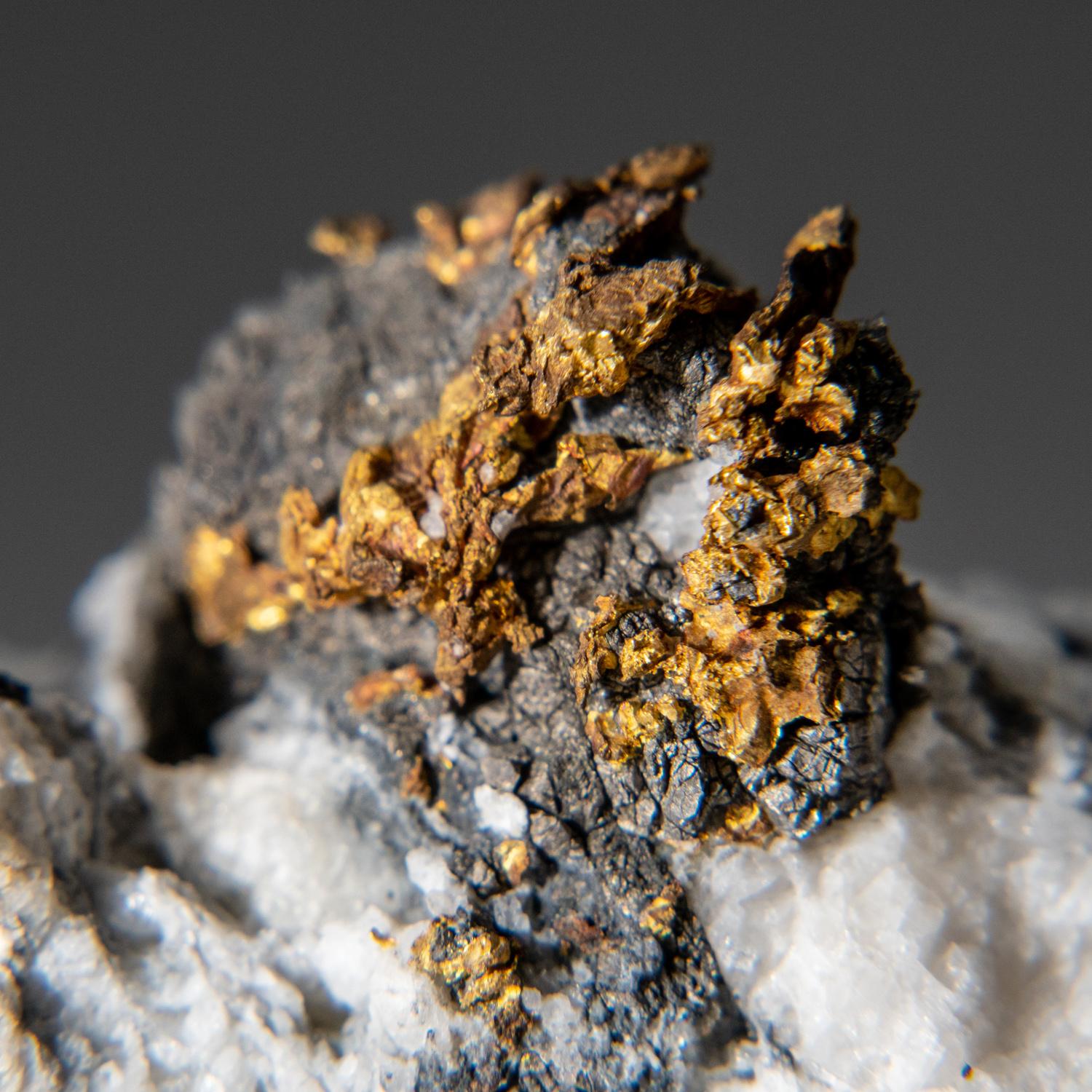 Well crystallized native (natural) gold running throughout arsenapyrite. The gold is perched atop the matrix.

Weight: 98.1 grams, Size: 2.5 x 1 x 1.5 inches