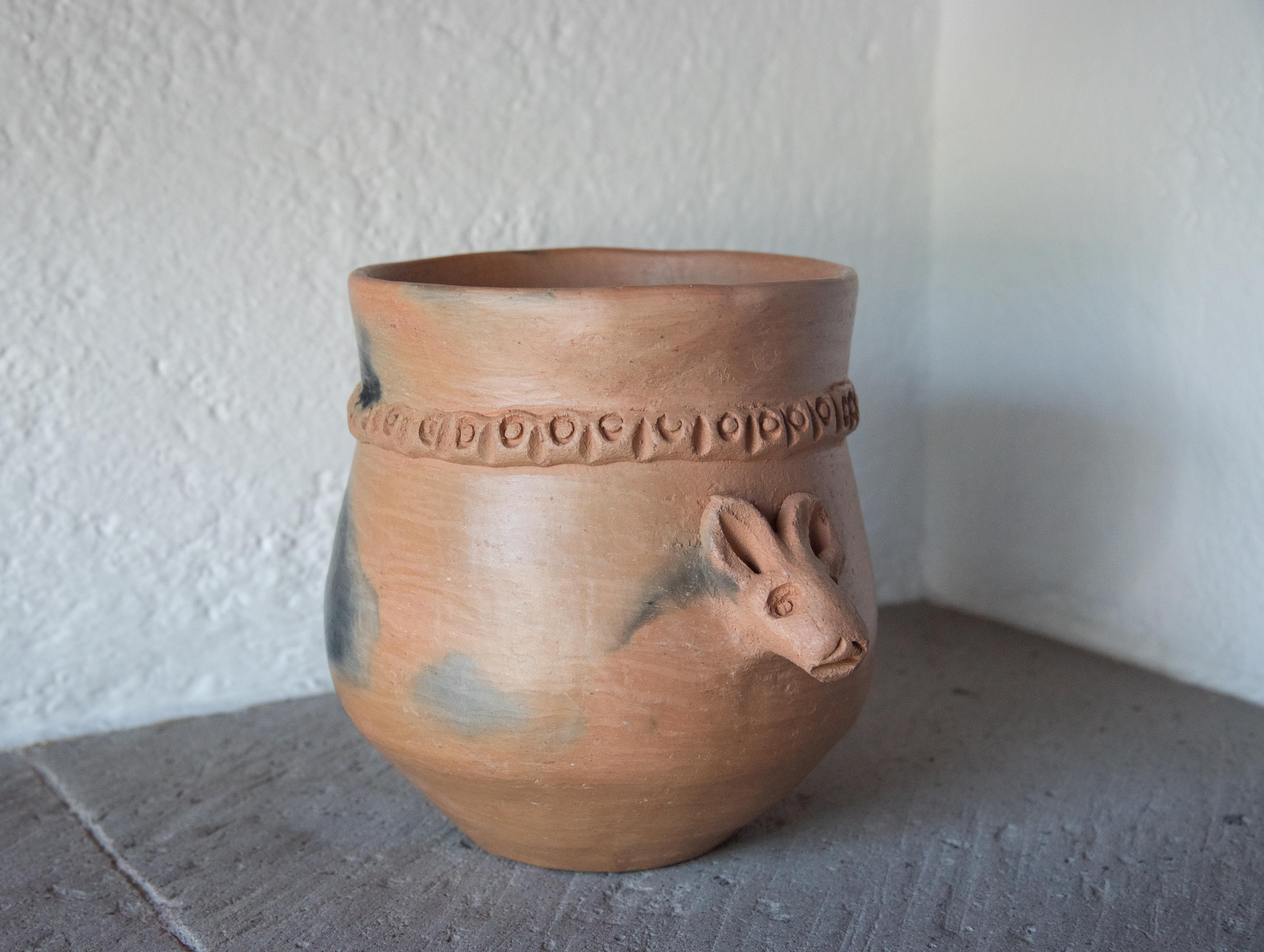 This humorous piece is a one of a kind by master artisan Silvia Martínez. Silvia sculpts a mouse's head on the front of the pot and the tail for the back of the pot. Made with natural clay from the region in a rustic style. The burnished clay