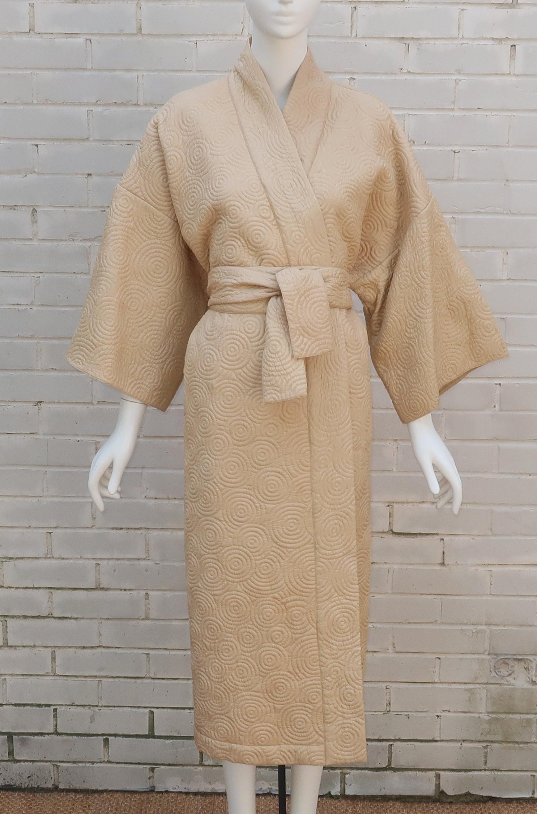 Relax in style with a Natori quilted silk robe in a lovely shade of champagne beige.  The kimono style silhouette has a classic open front, bell sleeves and wide sash belt.  There are hidden pockets on the side and a full lining.  The quilting has