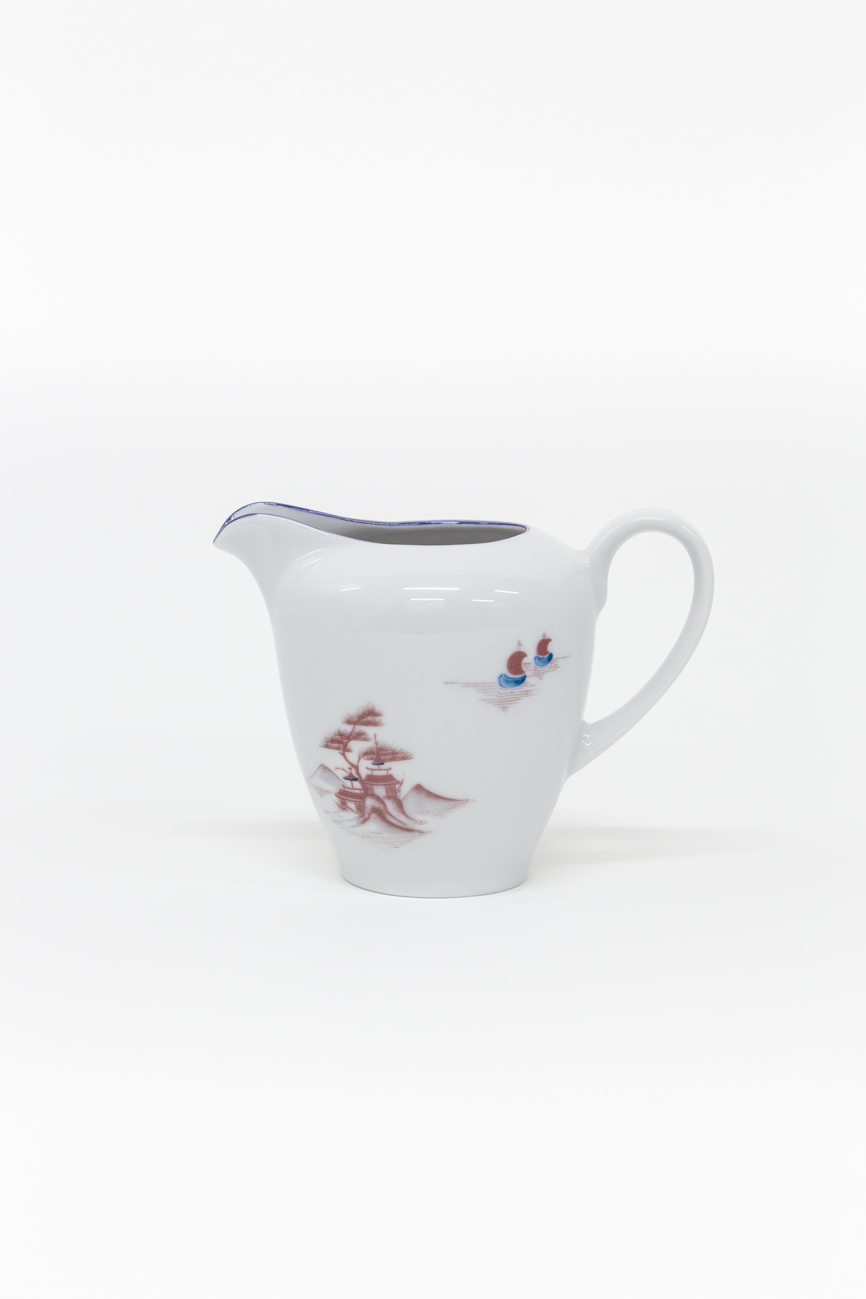 This Tea Time Set is part of the Natsumi Porcelain collection by Grand Tour by Vito Nesta. The Japanese lake landscape shows us figures going about their daily lives, Geisha conversing, men in small rowing boats and other scenes of bucolic life. All