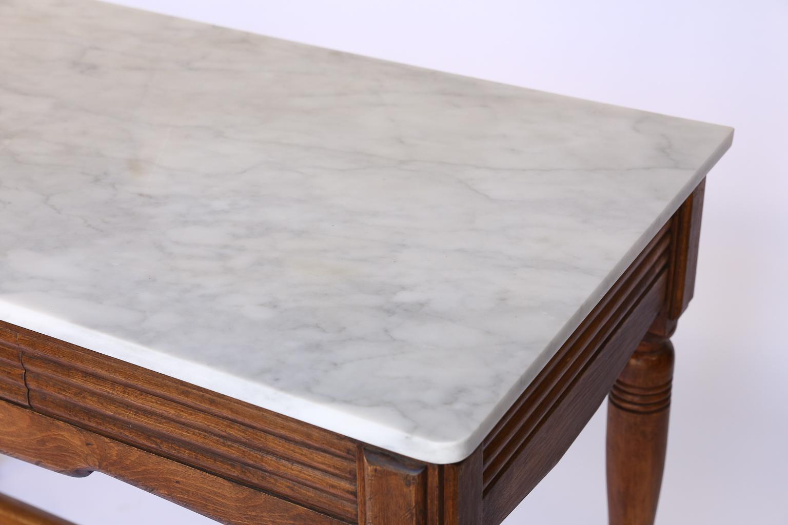 Found in France, this Natta and Nagot butcher table base has been updated with a new marble top. The table features one drawer, with a metal pull, which was originally used to store knives. The metal plate below the drawer reads NATTA & NAGOT. This