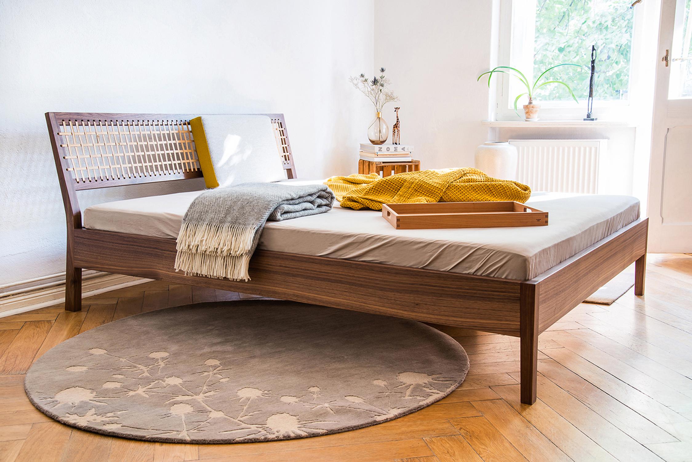 Natú Bench by Frau Caze
Dimensions: D 200 x W 180 x H 38.5 cm.
Materials: Oiled walnut, natural leather.

Available in 140, 160, or 180cm width.

Natú Bed is manufactured from walnut. The woven leather head board creates a light and natural