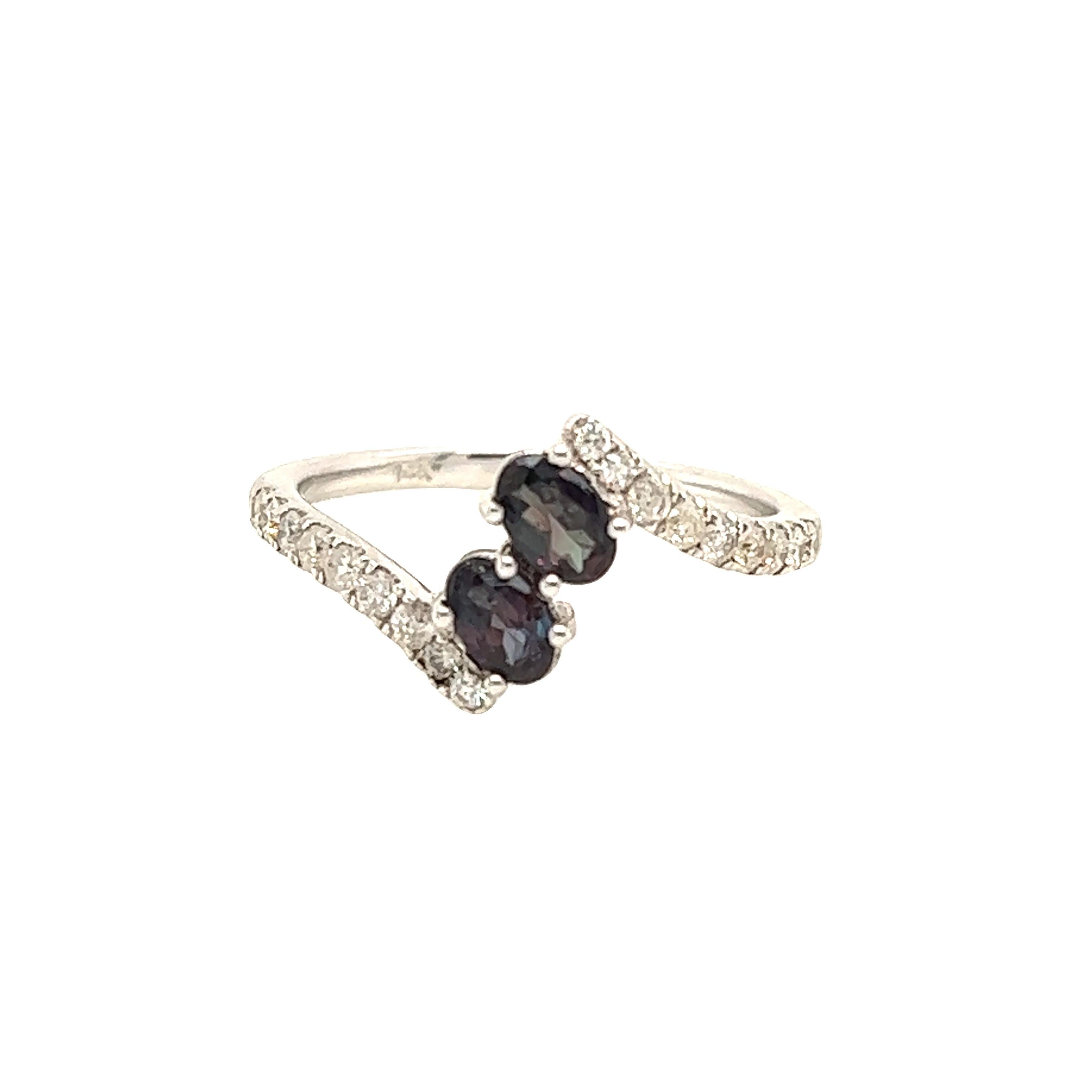 This is a gorgeous natural AAA quality oval Alexandrite surrounded by dainty diamonds that is set in a vintage white gold setting. This ring features a natural 0.48 carat oval alexandrite that is surrounded by brilliant white diamonds. The ring is a