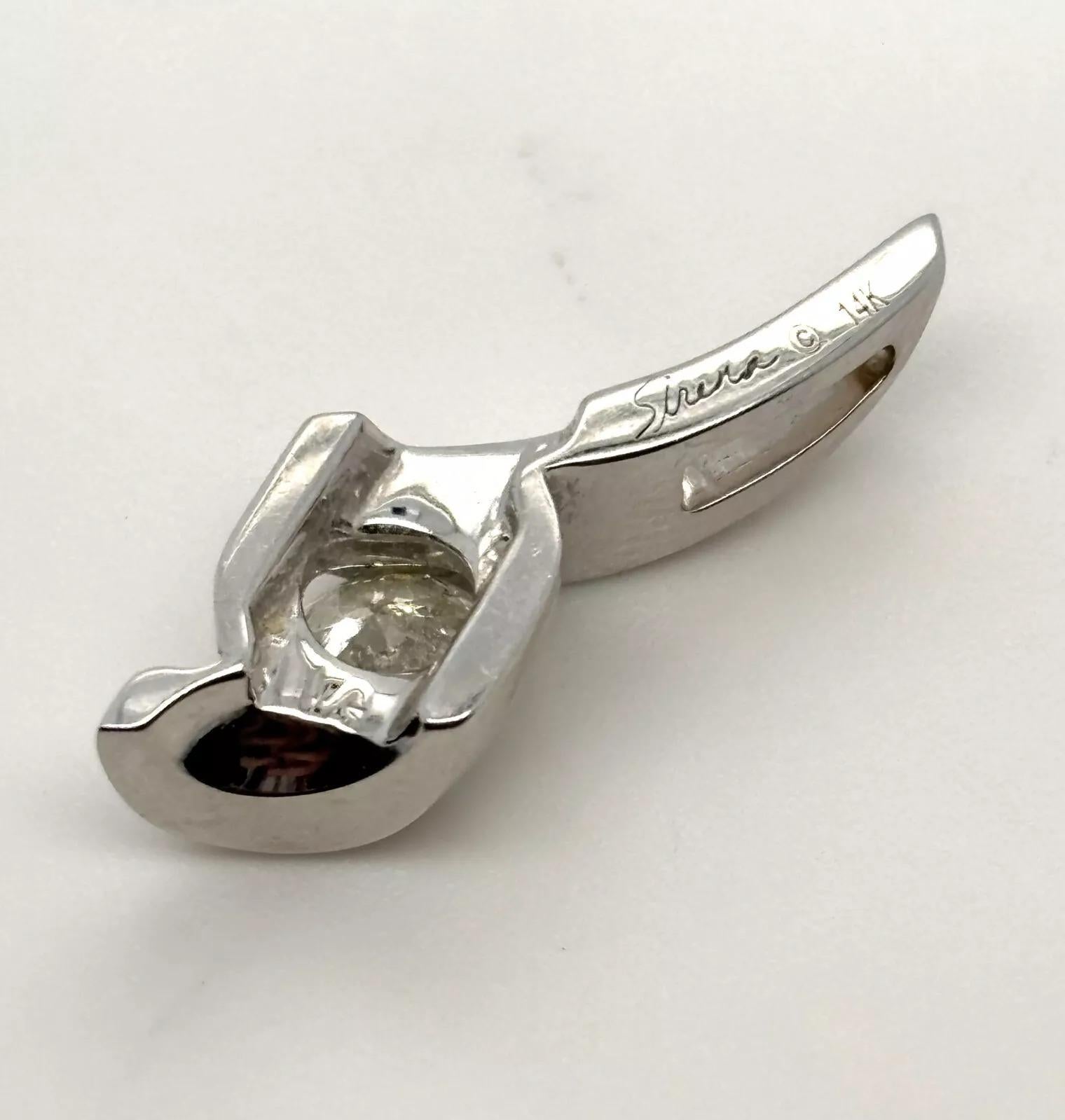 Offered is a timeless Sirena Solitaire Diamond Pendant, crafted in solid 14K white gold. This elegant design features a single natural round brilliant cut diamond weighing approximately 0.50 carats, graded I–J color and I1 clarity, set in a flowing