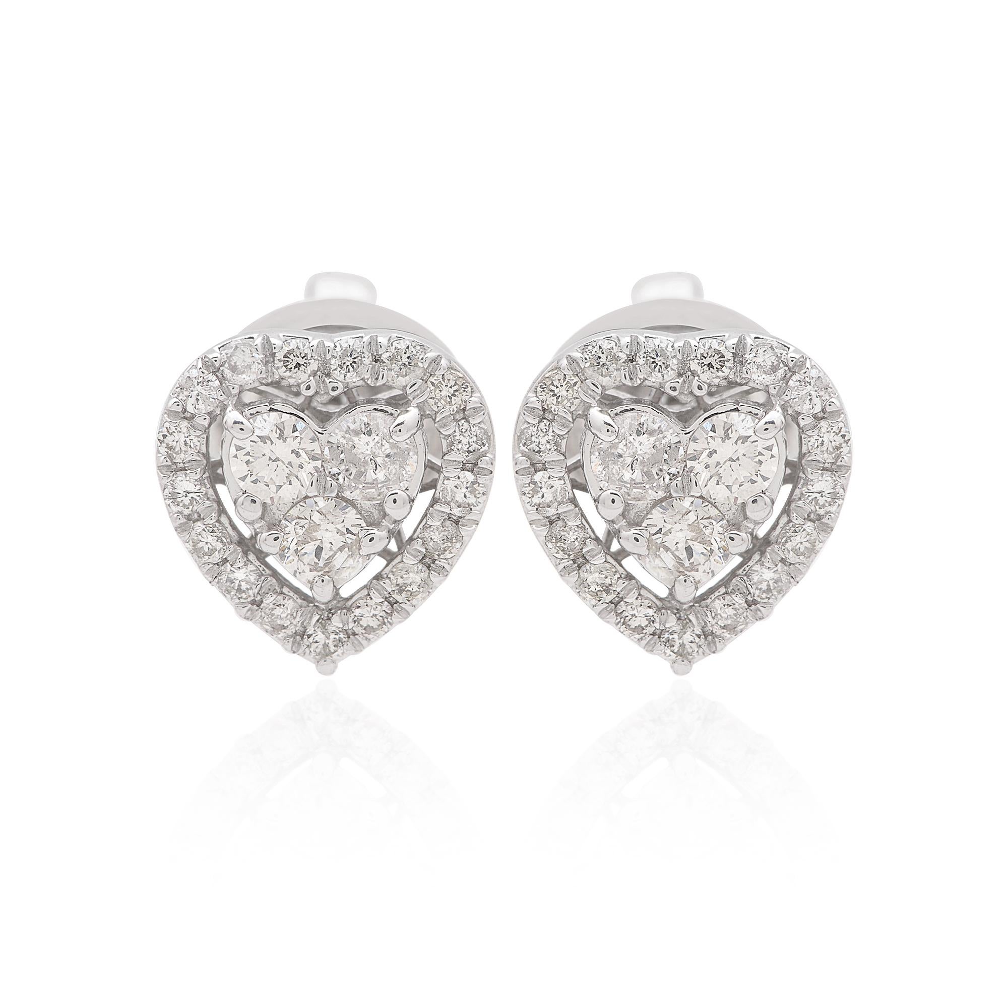 Each earring features a meticulously selected round diamond, totaling 0.55 carats for the pair, expertly set within a delicate heart-shaped setting. The brilliance and fire of these diamonds are accentuated by their pristine clarity and
