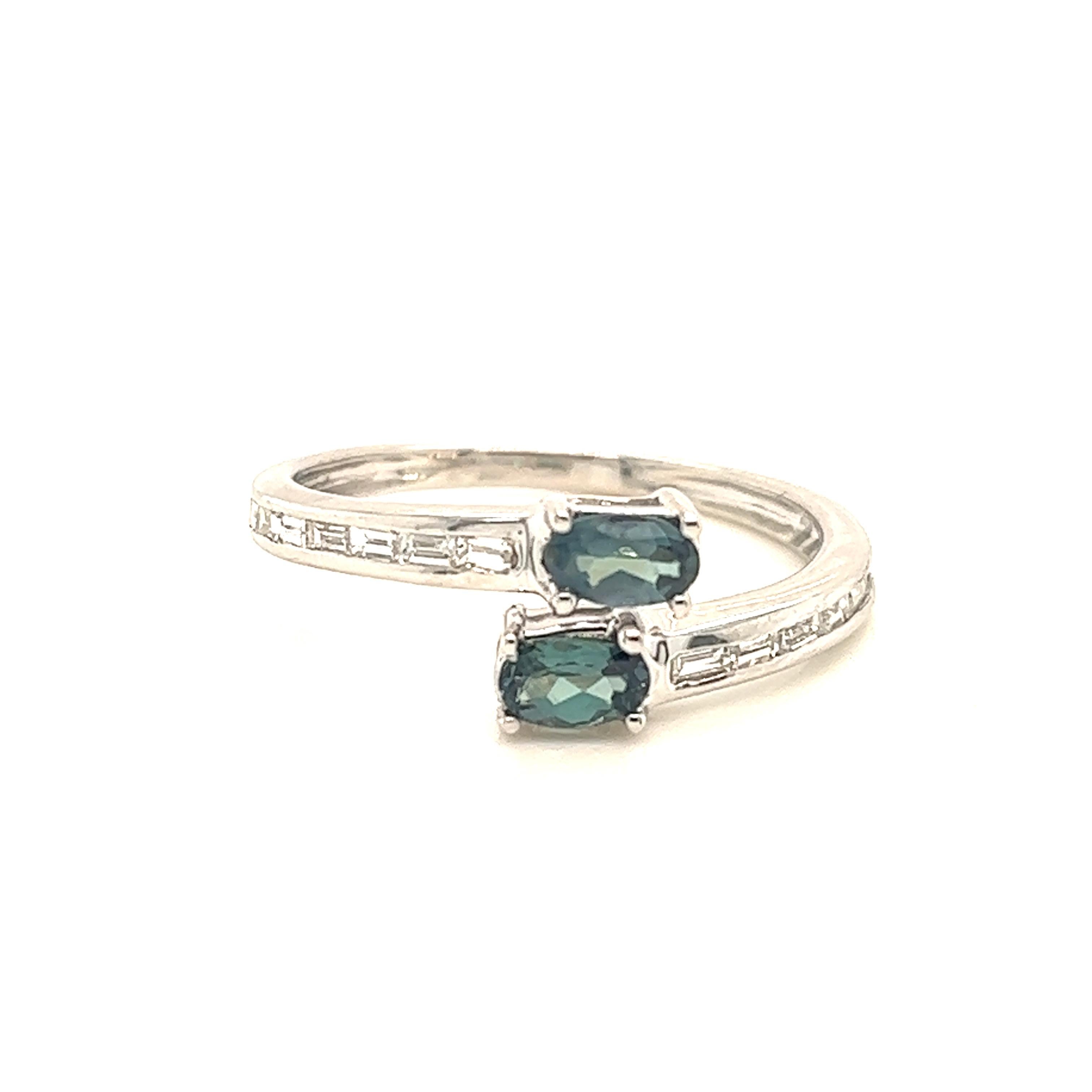 This is a gorgeous natural AAA quality Alexandrite surrounded by dainty diamonds that is set in a vintage White Gold setting. This ring features a natural 0.57 carat oval alexandrite that is surrounded by brilliant white diamonds. The ring is a true