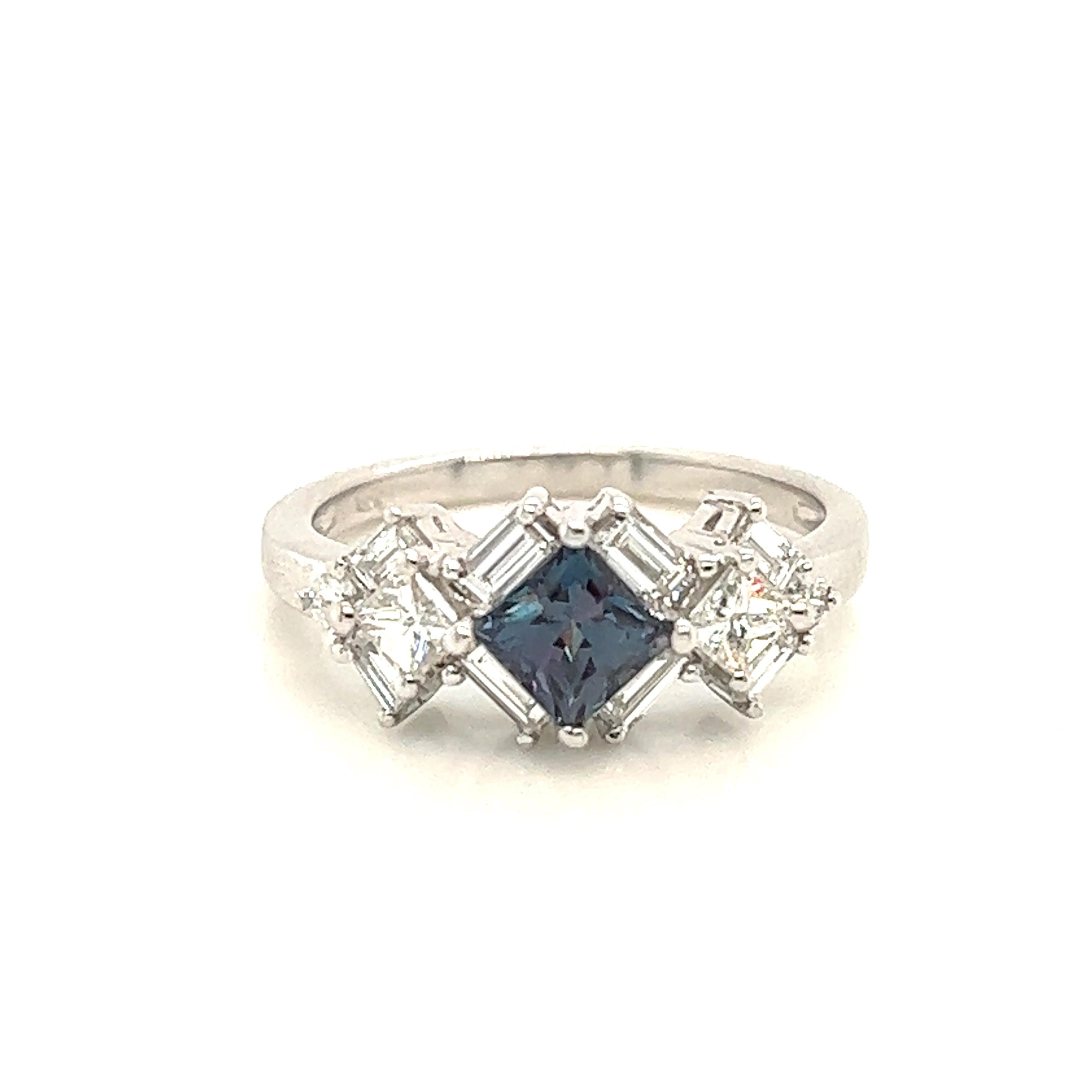 This is a gorgeous natural AAA quality Alexandrite surrounded by dainty diamonds that is set in a vintage setting. This ring features a natural 0.64 carat princess alexandrite that is surrounded by brilliant white diamonds. The ring is a true