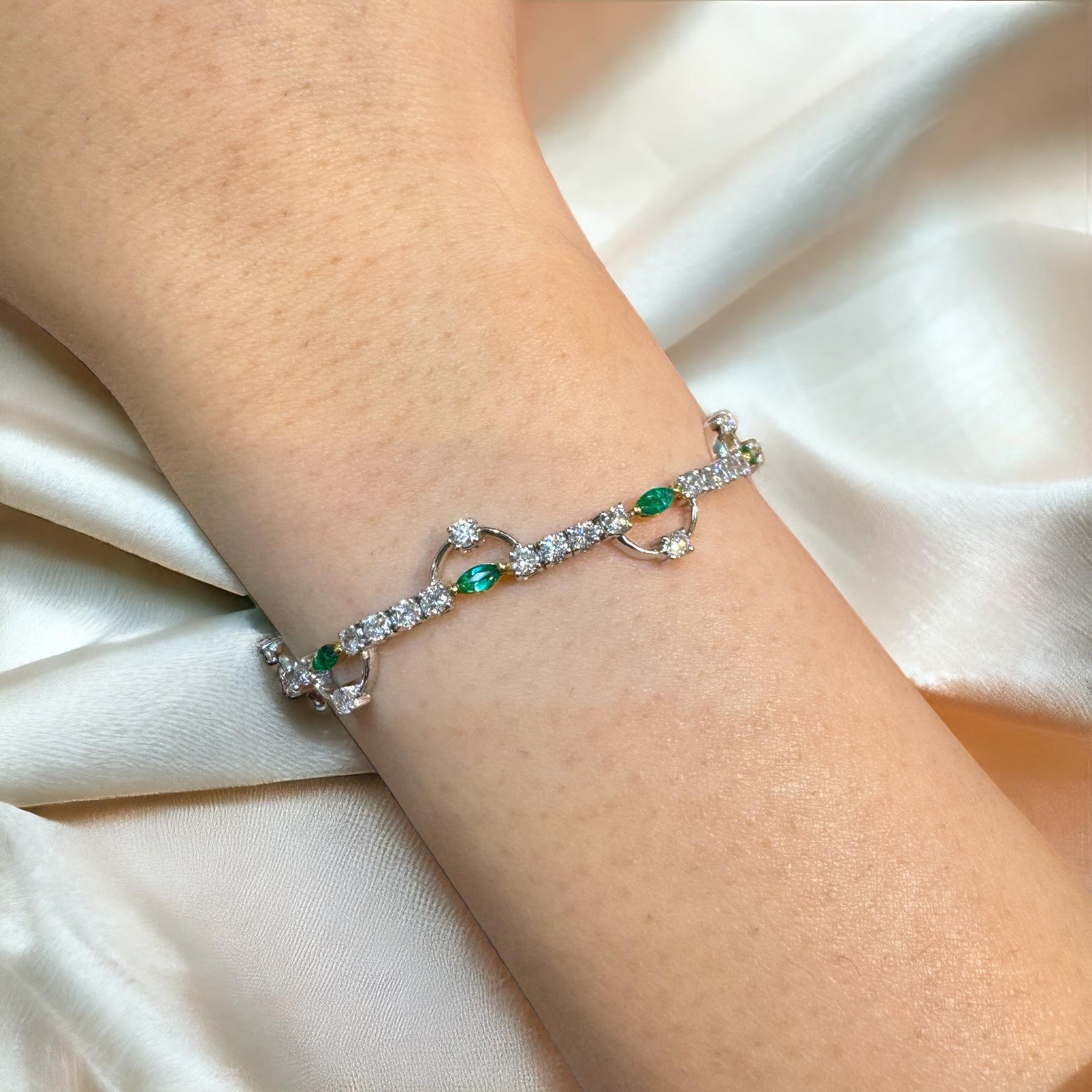 Natural Emerald & Diamond Charm Bracelet in 18K White Gold. 

Natural Marquise cut 10 pieces of emerald, weighing 0.72 carats total. 51 round-cut diamonds totaling 2.08 carats. All set in 18K white gold, weighing 7.34 grams with a 6.5 inch length.