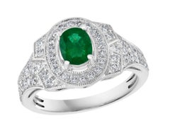 Anillo de oro blanco de 18 quilates con una esmeralda natural de 0,80 quilates de talla ovalada y un diamante de 0,85 quilates