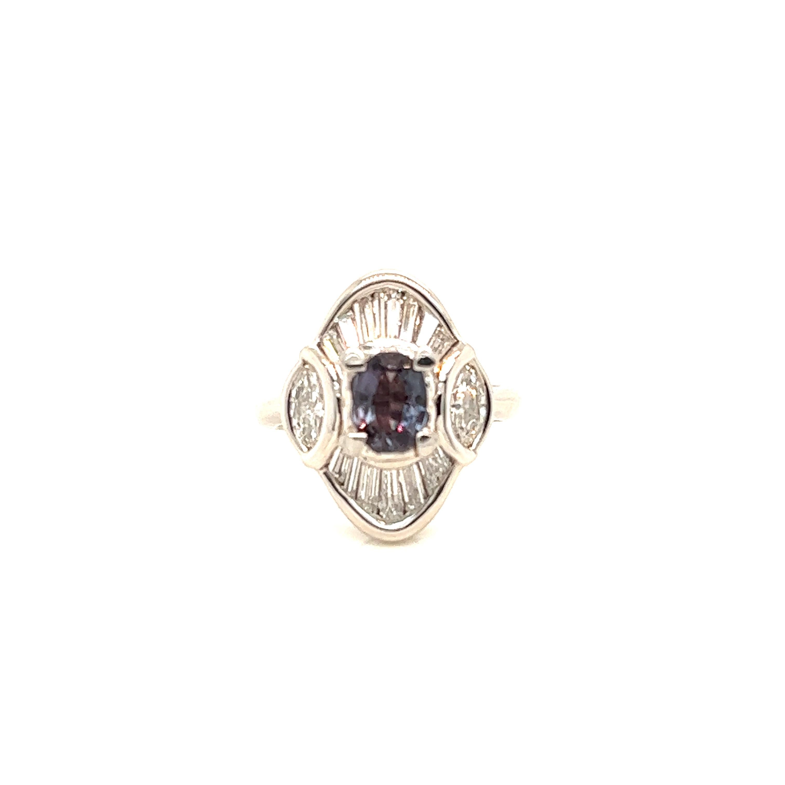 This is a gorgeous natural AAA quality cushion Alexandrite surrounded by dainty diamonds that is set in a vintage platinum setting. This ring features a natural 0.84 carat cushion alexandrite that is surrounded by brilliant white diamonds. The ring