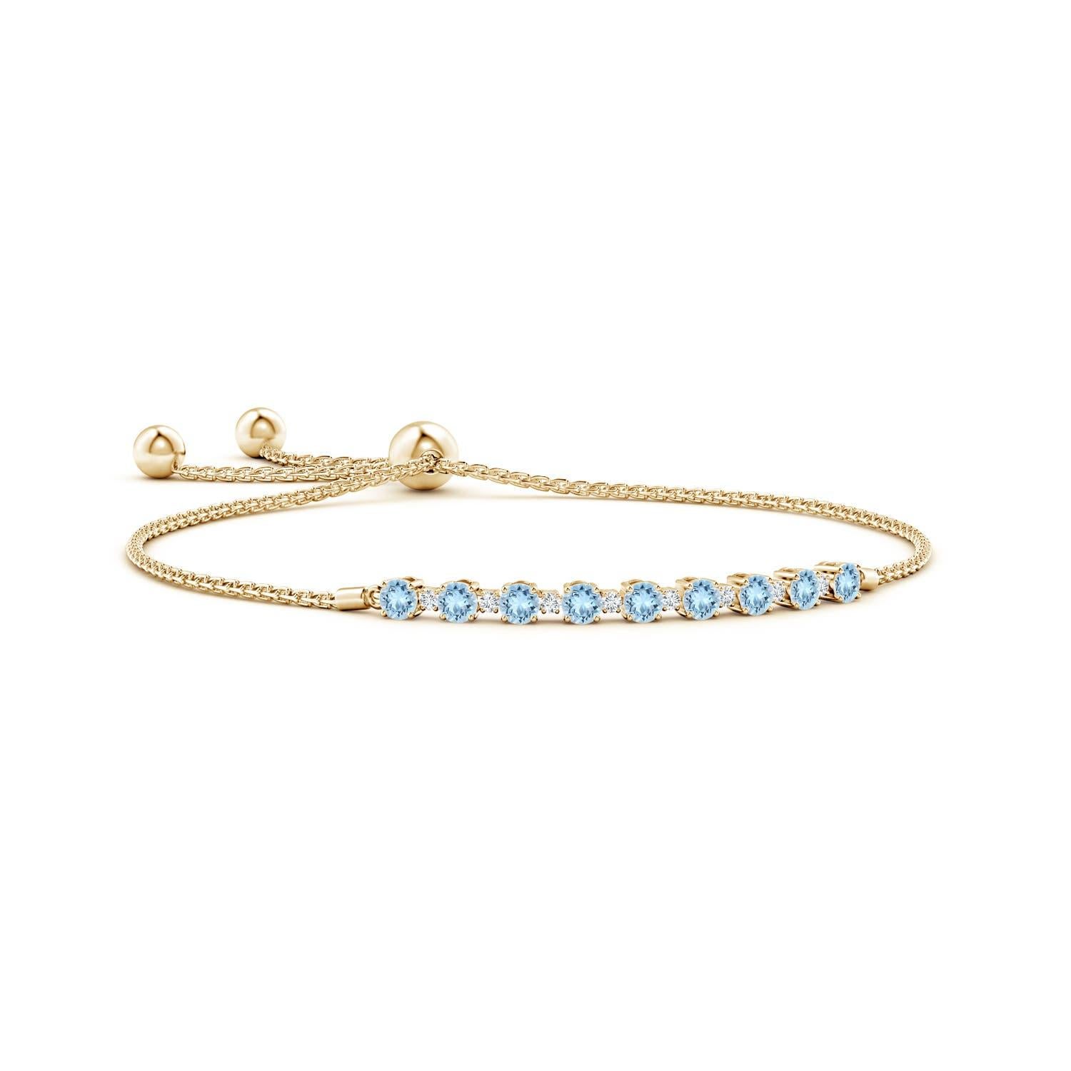 Sea blue aquamarines and glittering diamonds come together on this 14k yellow gold tennis bolo bracelet. They are prong set alternately and create a classic look. This bracelet is adjustable to fit most wrists.