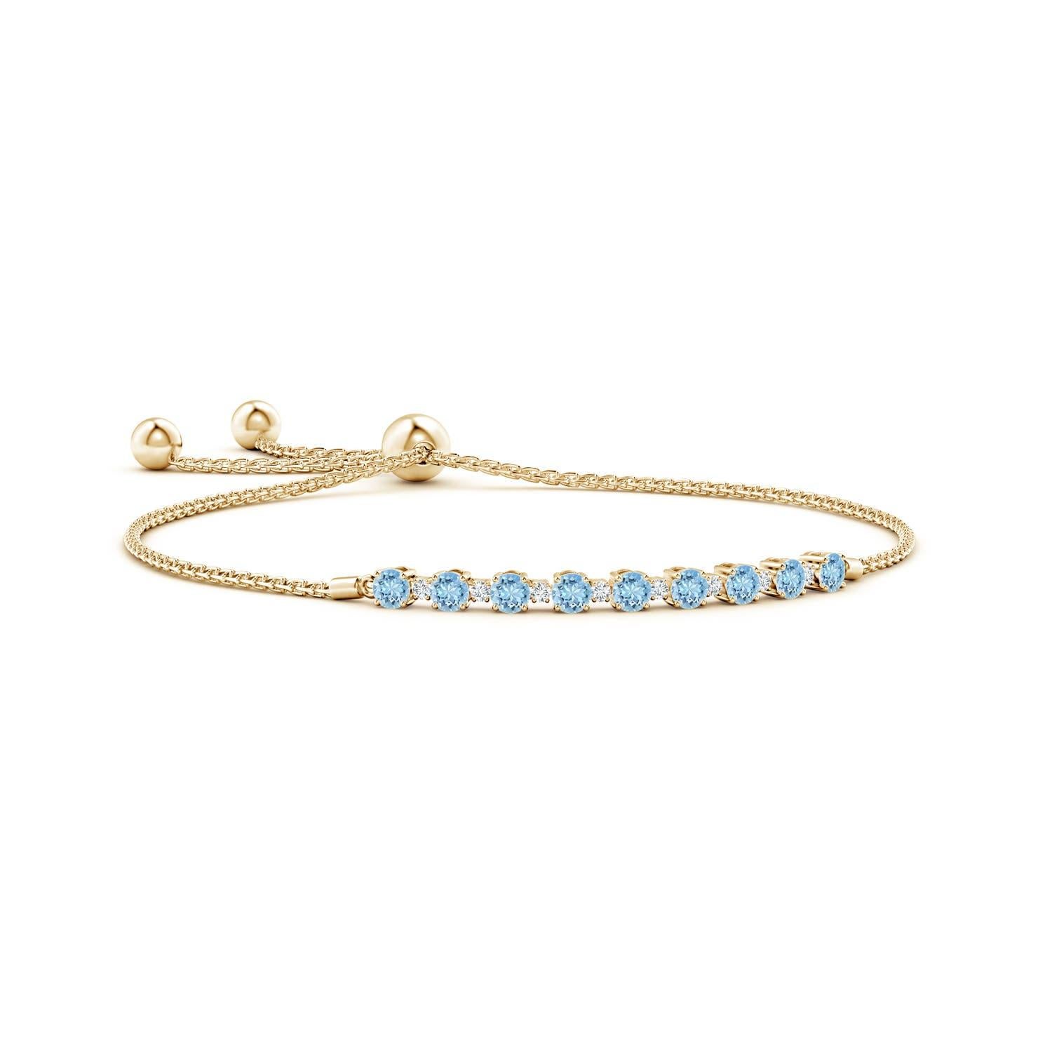 Sea blue aquamarines and glittering diamonds come together on this 14k yellow gold tennis bolo bracelet. They are prong set alternately and create a classic look. This bracelet is adjustable to fit most wrists.