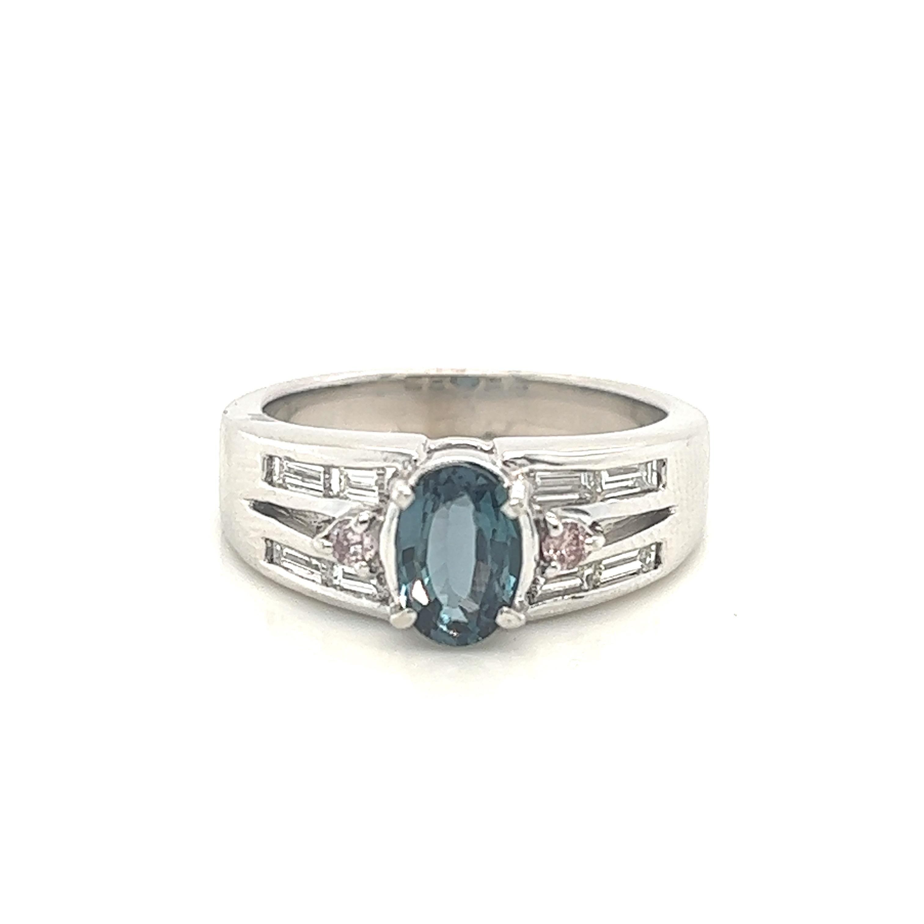 This is a gorgeous natural AAA quality Alexandrite surrounded by dainty diamonds that is set in a vintage platinum setting. This ring features a natural 0.97 carat oval alexandrite that is surrounded by brilliant white diamonds. The ring is a true
