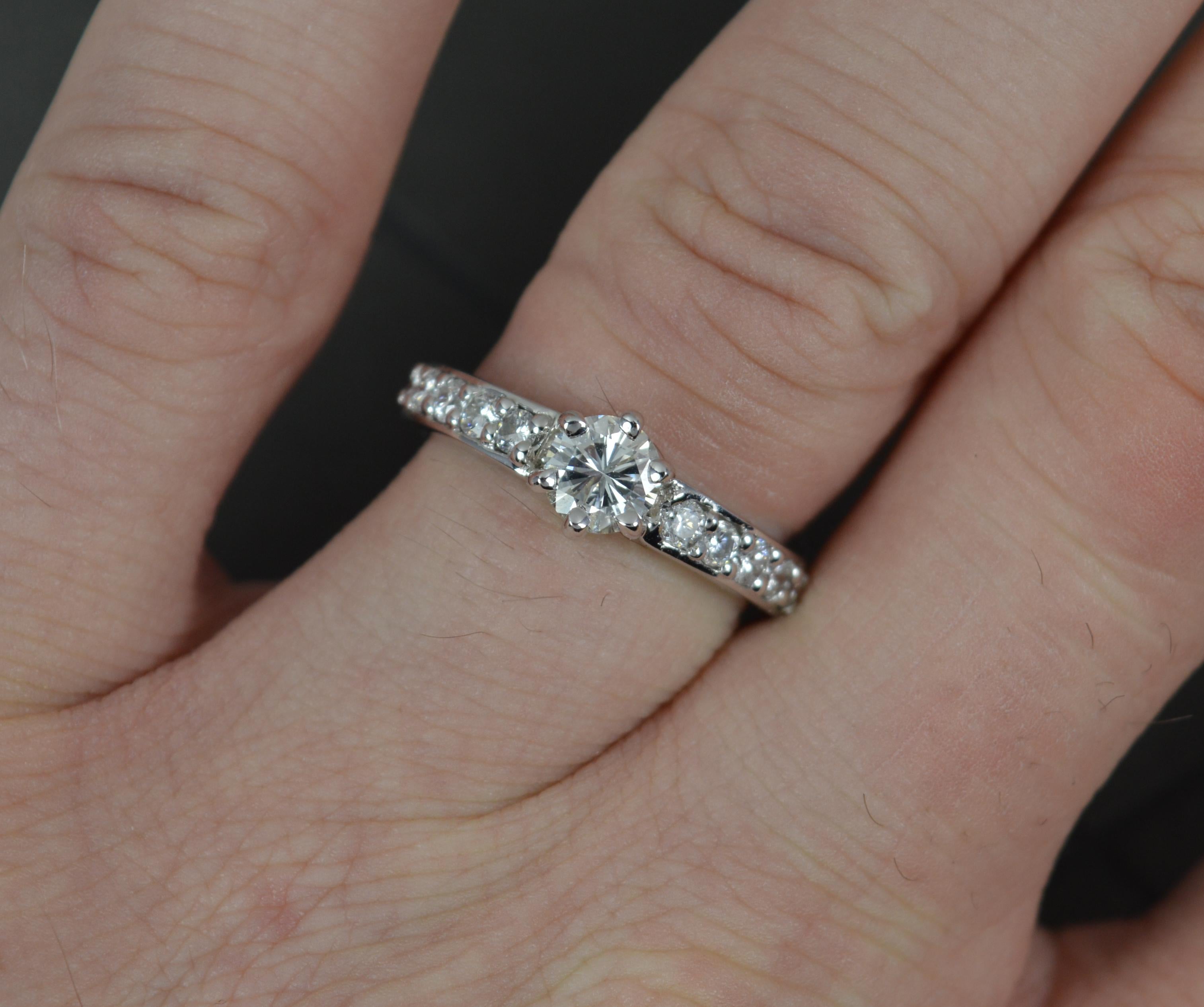 A wonderful diamond engagement ring.
Solid 18 carat white gold shank and six claw setting.
Designed with a single round brilliant cut diamond to centre, 0.5cts. Set with an additional five round brilliant cut diamonds to each shoulder. 0.90 carat