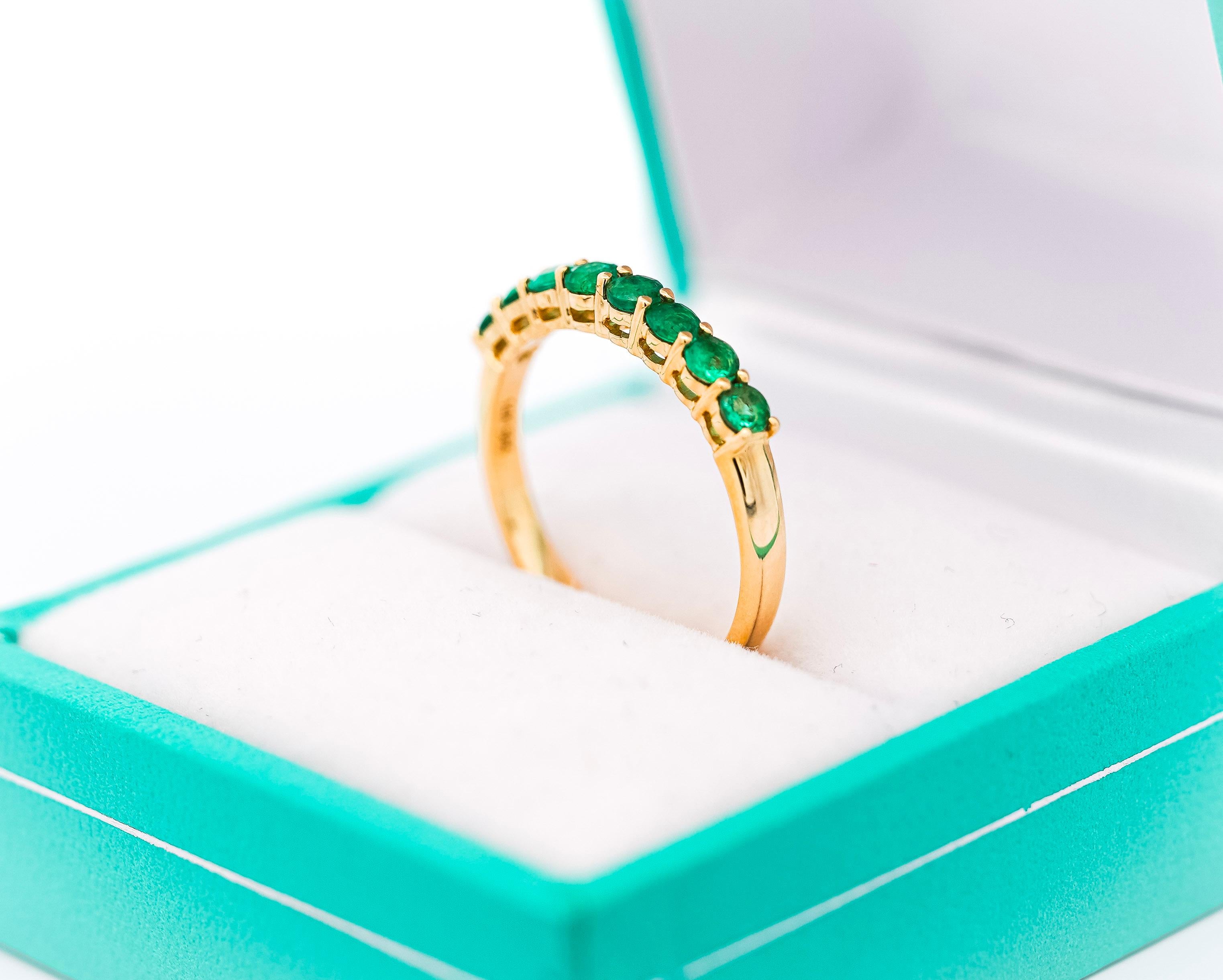 Natural Green Emerald Wedding Band Ring, Set in 14K Solid Yellow Gold. Featuring a 2.2mm band and substantially large round-cut emeralds. The perfect emerald band that's big enough to be noticed on your finger, but not too bulky. The emeralds are