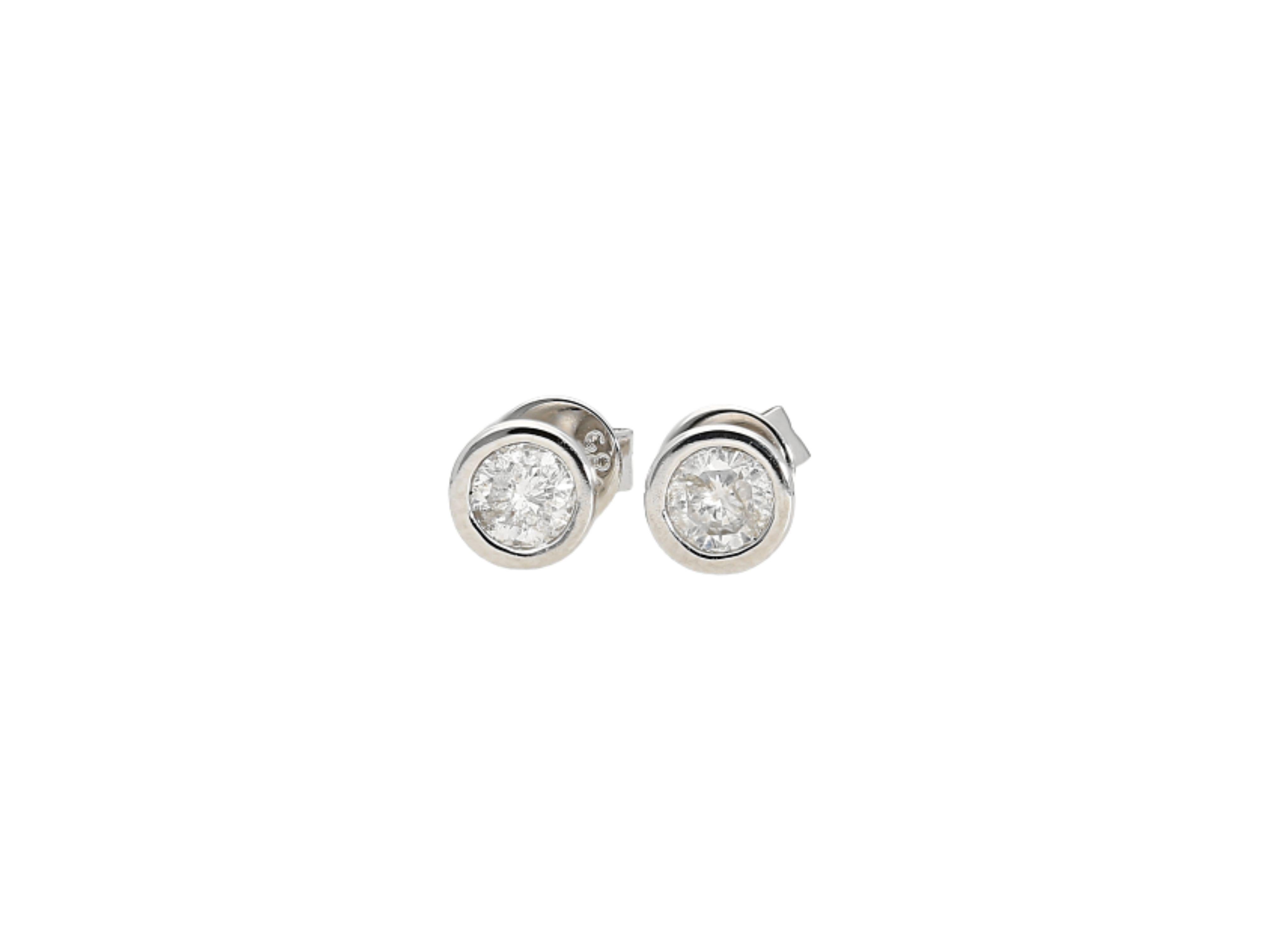 Simple and elegant natural diamond stud earrings bezel set in 14 karat white gold for long-lasting and durable use. These diamonds are 100% natural, mined diamonds. Set in 14k solid white gold. The ideal everyday pair of diamond stud earrings that
