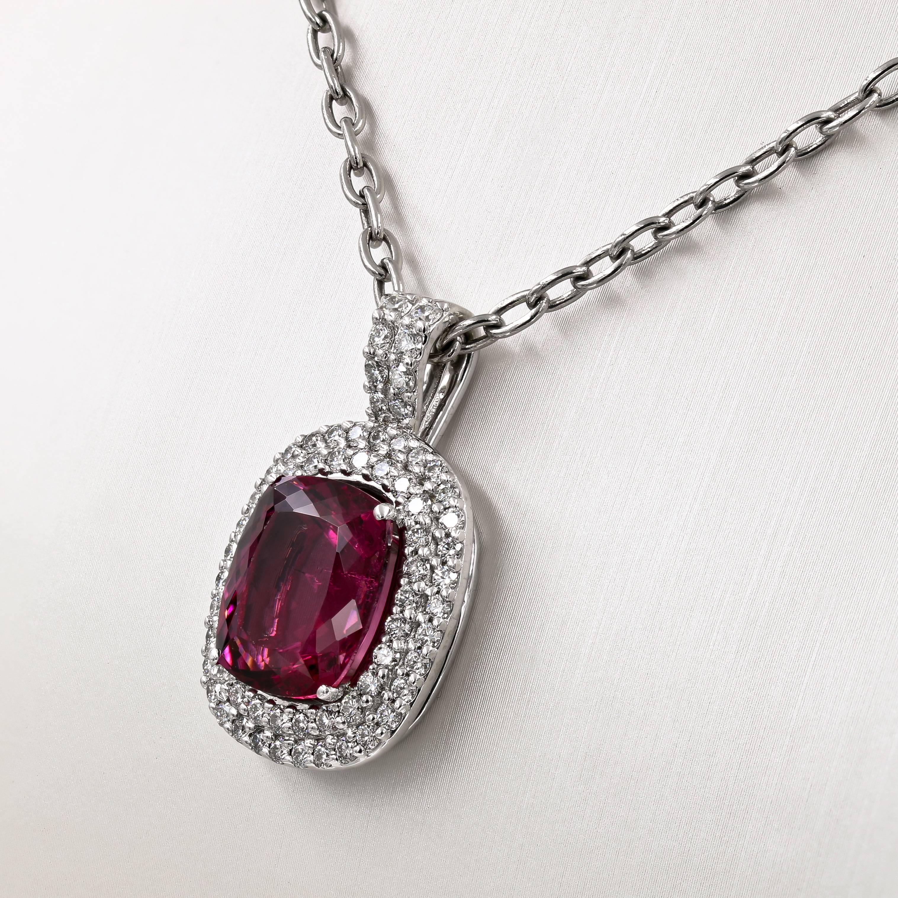 This spectacular 10.91cts. natural tourmaline is Burgundy in color, and is originally from Madagascar. Set in 18kt. white gold, it is surrounded by 68 ideal cut round diamonds= 1.72cts. t.w. The diamonds are GH color and VS clarity. The piece is