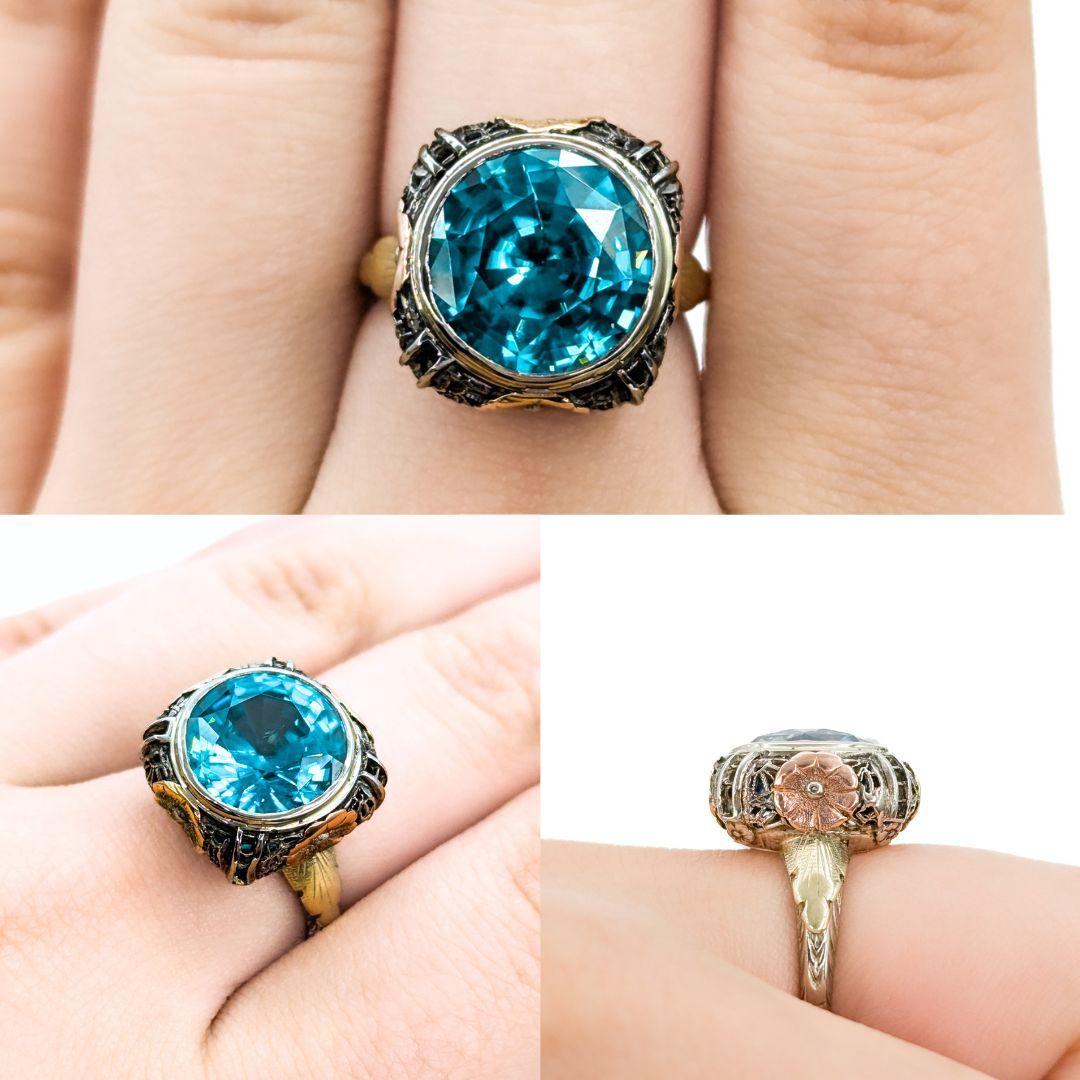 Vintage Elegance: 14k Two-Tone Blue Zircon Ring

Introducing this beautiful Gemstone Fashion Ring crafted in 14k Two-Tone gold. The ring features a stunning 10.9ct round Blue Zircon at its centerpiece, embodying the vintage style's timeless