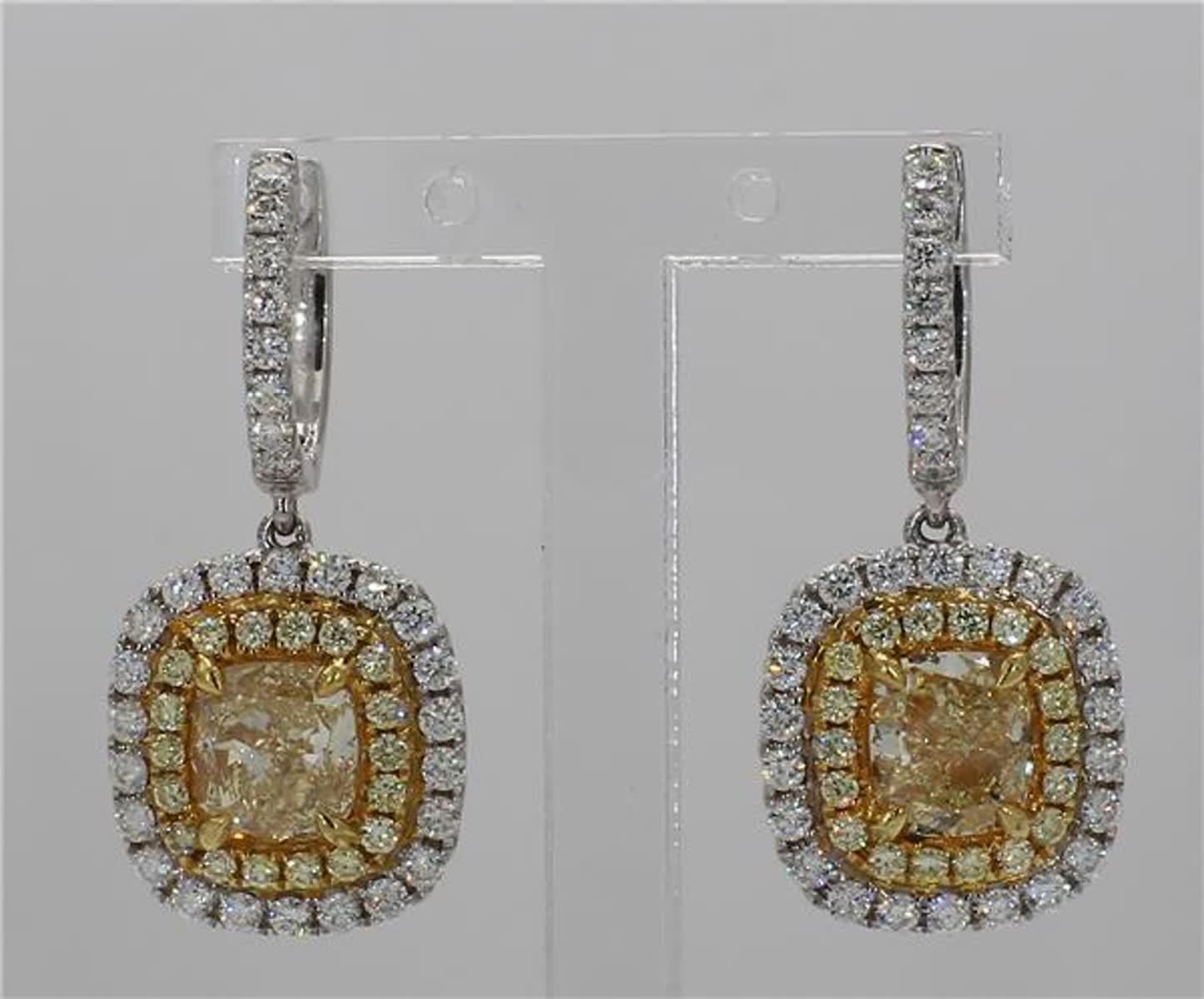 RareGemWorld's classic natural cushion cut yellow diamond earrings. Mounted in a beautiful 18K Yellow and White Gold setting with natural cushion cut yellow diamonds. The yellow diamonds are surrounded by small round natural white diamond and yellow