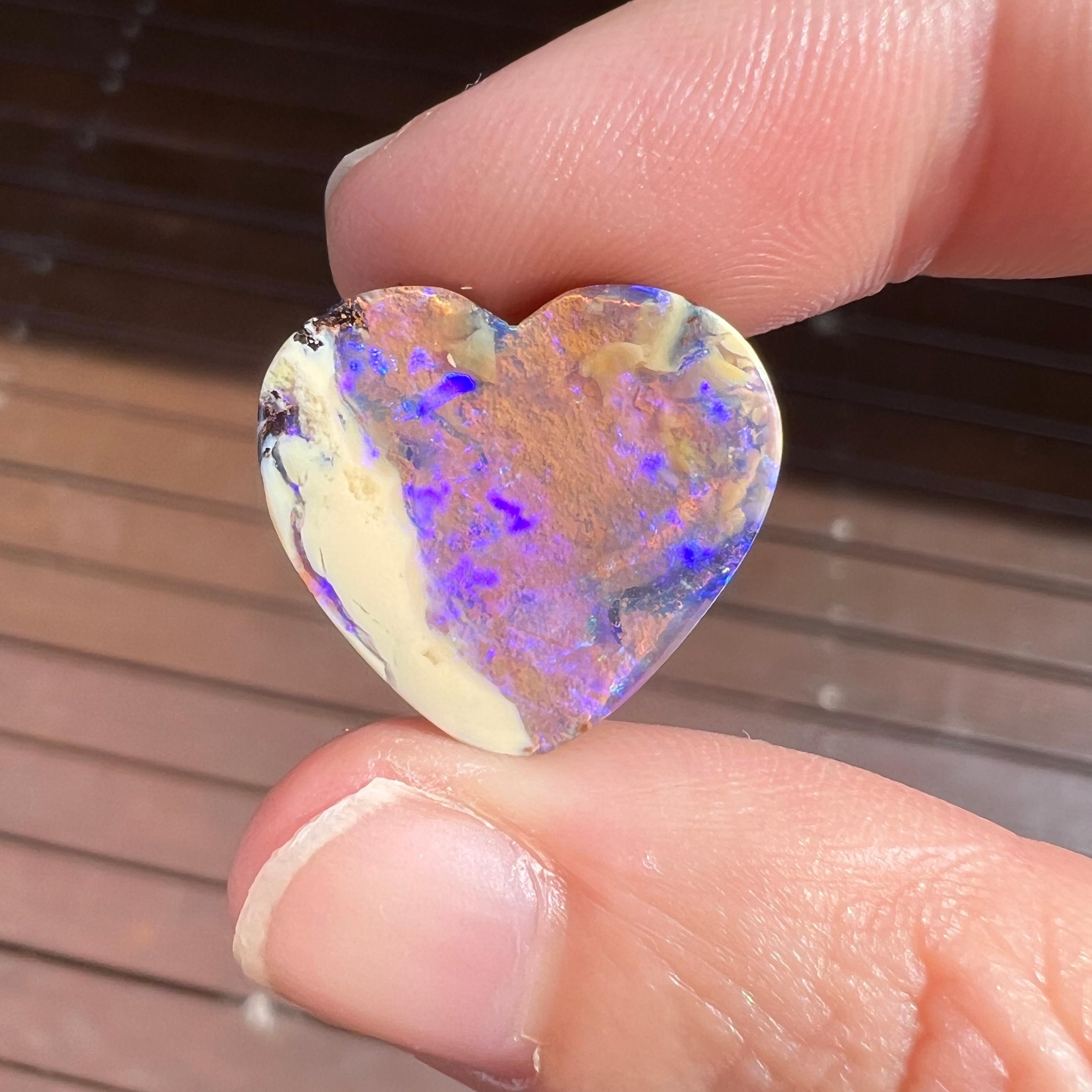 This beautiful 12.54 Ct Australian boulder opal was mined by Sue Cooper at her Yaraka opal mine in western Queensland, Australia in 2021. Sue processed the rough opal herself and cut into into an large heart shape. We especially love the flashy