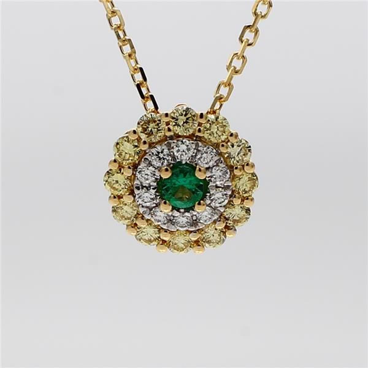 RareGemWorld's classic emerald pendant. Mounted in a beautiful 18K Yellow and White Gold setting with a natural round cut emerald. The emerald is surrounded by natural round yellow diamond melee and natural round white diamond melee in a beautiful