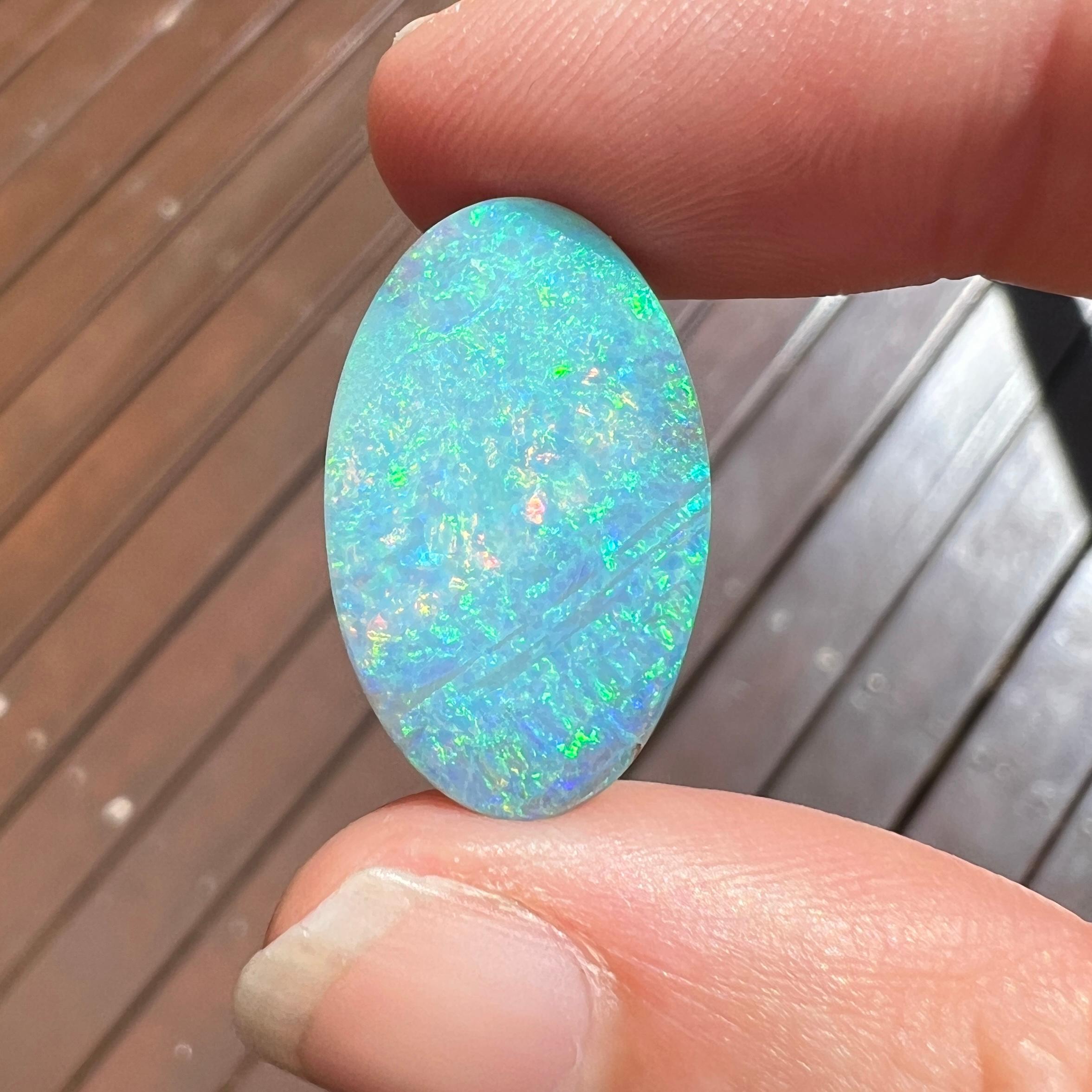 Discover the mesmerising beauty of this exquisite 13.31 Ct Australian Boulder oval opal, mined by Sue Cooper from her Mt. Margaret opal mine in Western Queensland, Australia.  

This particular gem holds a special place in our heart. Carefully cut