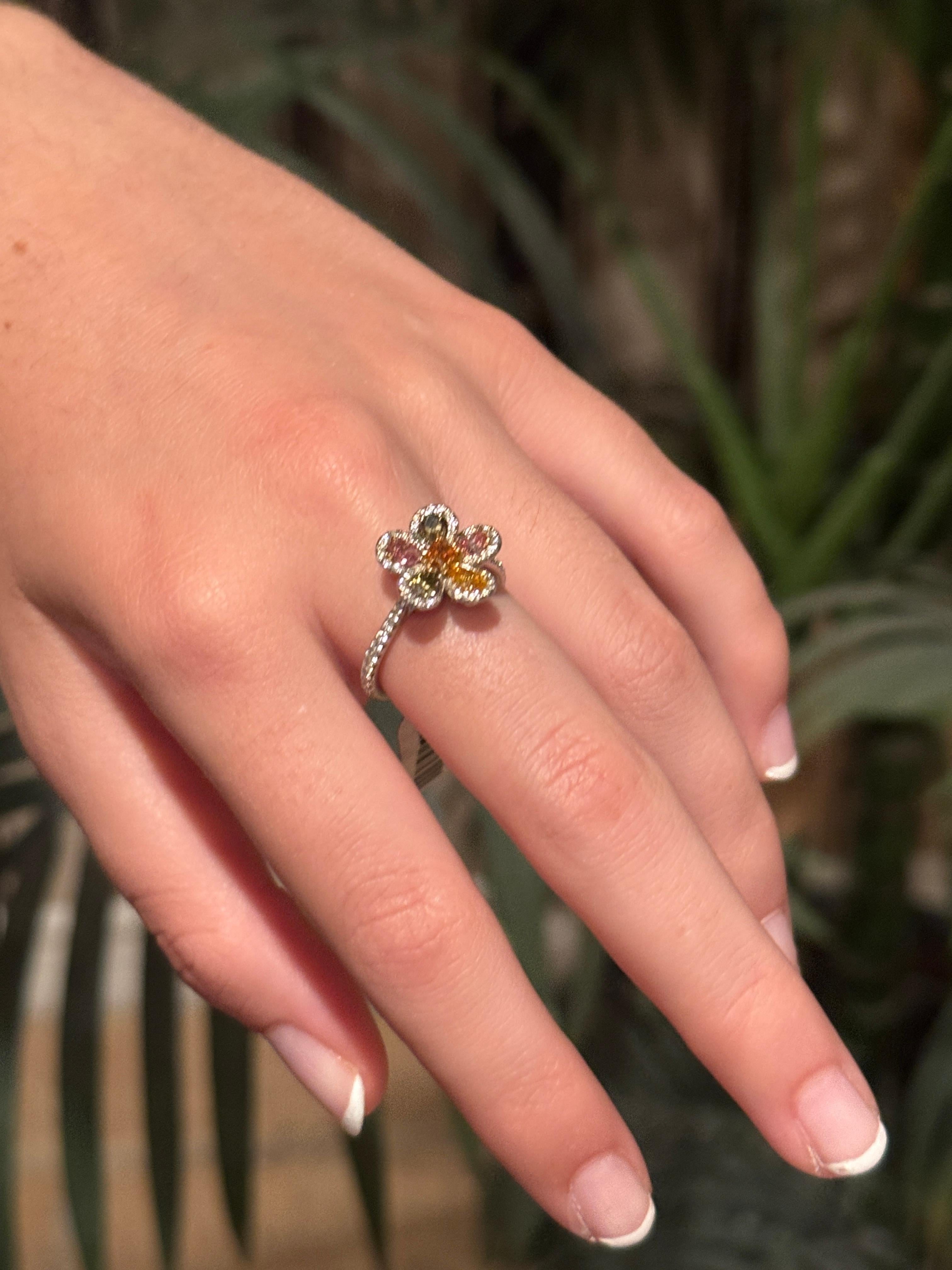 This exquisite multi-color floral diamond ring features a vibrant 0.14-carat orange cushion-cut diamond at its center. Surrounding it are five pear-shaped natural fancy color diamonds:
0.17-carat orange diamond 
0.16-carat and 0.18-carat green