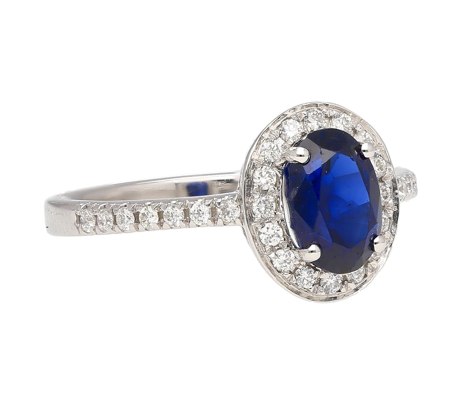 Natural Blue Sapphire and White Diamond Halo Ring in 18k White Gold. Featuring a thin shank, eye clean diamonds, and a low profile/elevation that sits beautifully on the finger during wear. The gemstones are all natural and set in 18k solid gold.