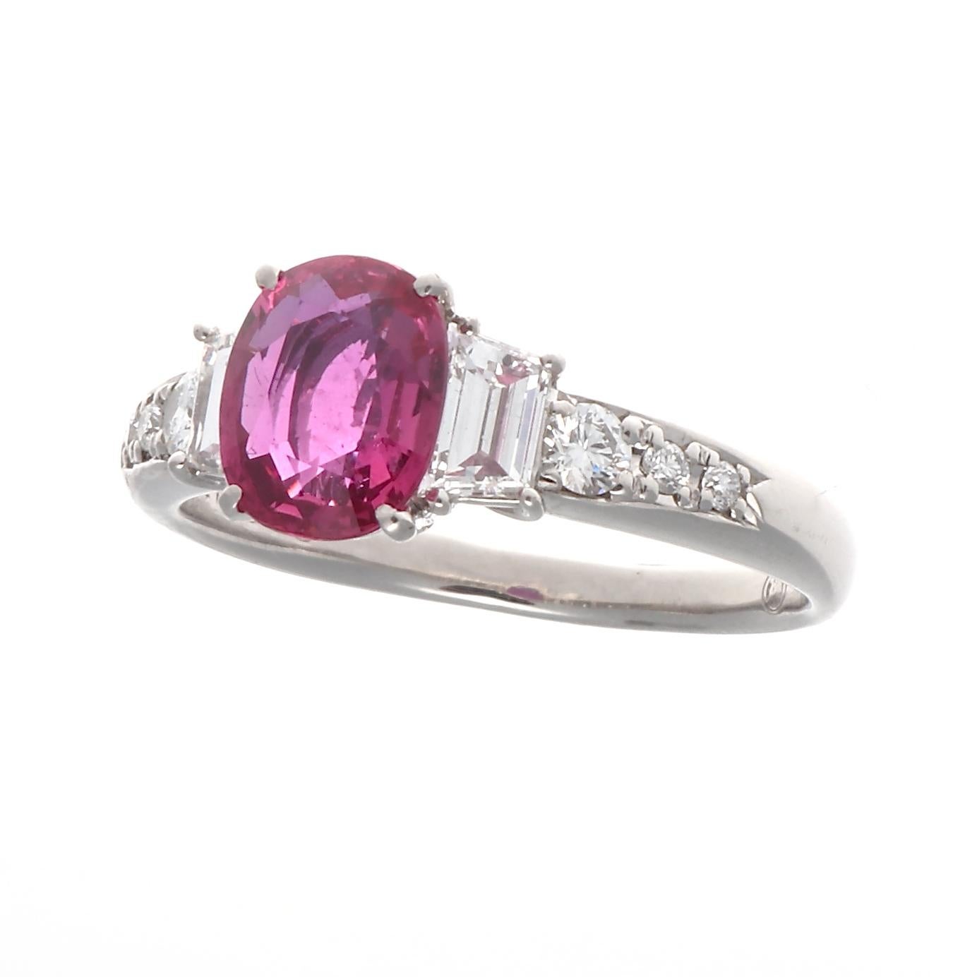 A sensation of color sparkles from this modern creation. Featuring a Guild Laboratory certified 1.64 carat no heat Ceylon ruby accented by 0.62 carats of cascading trapezoidal and round cut colorless diamonds. Crafted in platinum. Ring size 6 and