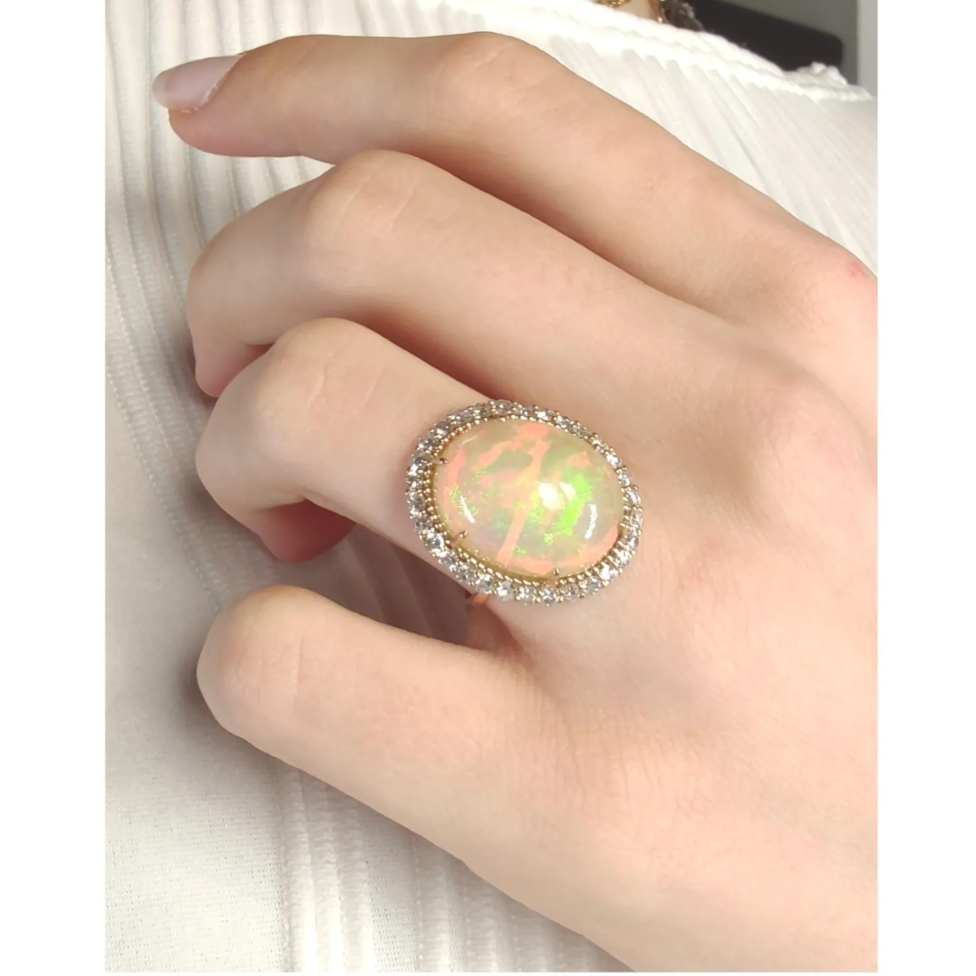 This breathtaking statement ring is a true masterpiece of fine jewelry, featuring a stunning 16.47ct natural untreated opal, expertly set in 14K rose gold. The opal's vivid yellow-translucent hue and exceptional cabochon cut make it a standout