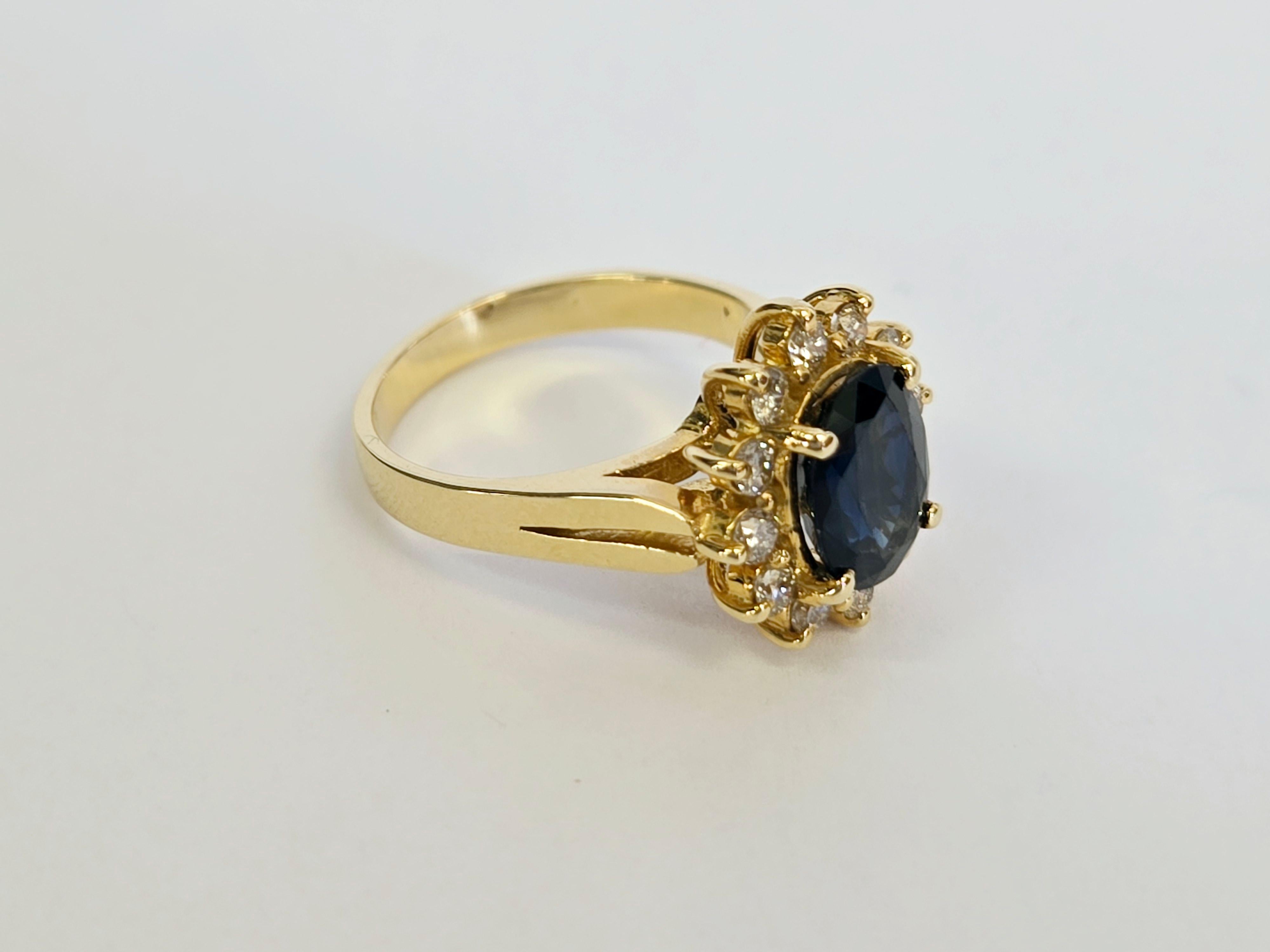 This ring features a natural blue sapphire weighing approximately 1.78 carats, encircled by 12 natural diamonds with a total weight of about 0.48 carats. Set in a 14K gold mounting, the ring is about size 5. It is accompanied by an AIGL appraisal