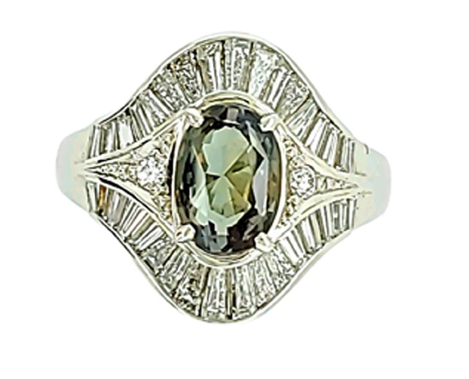 A large 1.80ct Natural Alexandrite Oval set with 1.23cts of Diamonds in a Platinum Ring - Estate Piece and believed to be only a few years old. Weight of the Alexandrite, the diamonds and metal type are all stamped on the inside of the band.