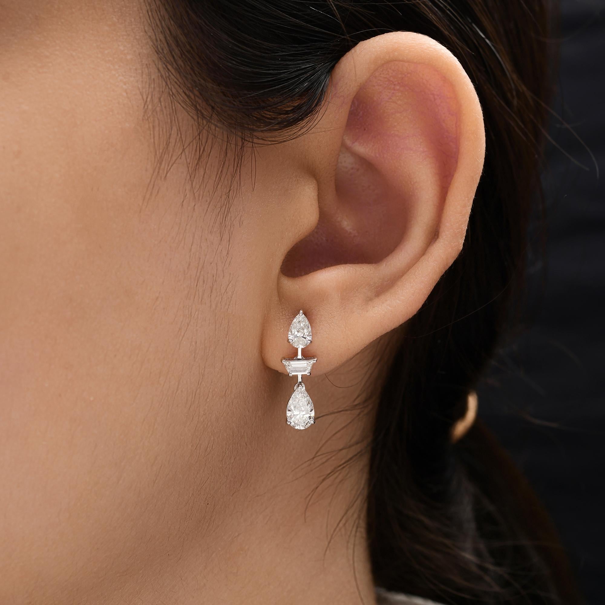 Natural 1.89 Ct SI Clarity HI Color Diamond Drop Earrings 18 Karat White Gold 
Designed with refined balance, each earring features two pear-cut diamonds delicately cascading around a striking baguette-cut diamond centerpiece. The polished white