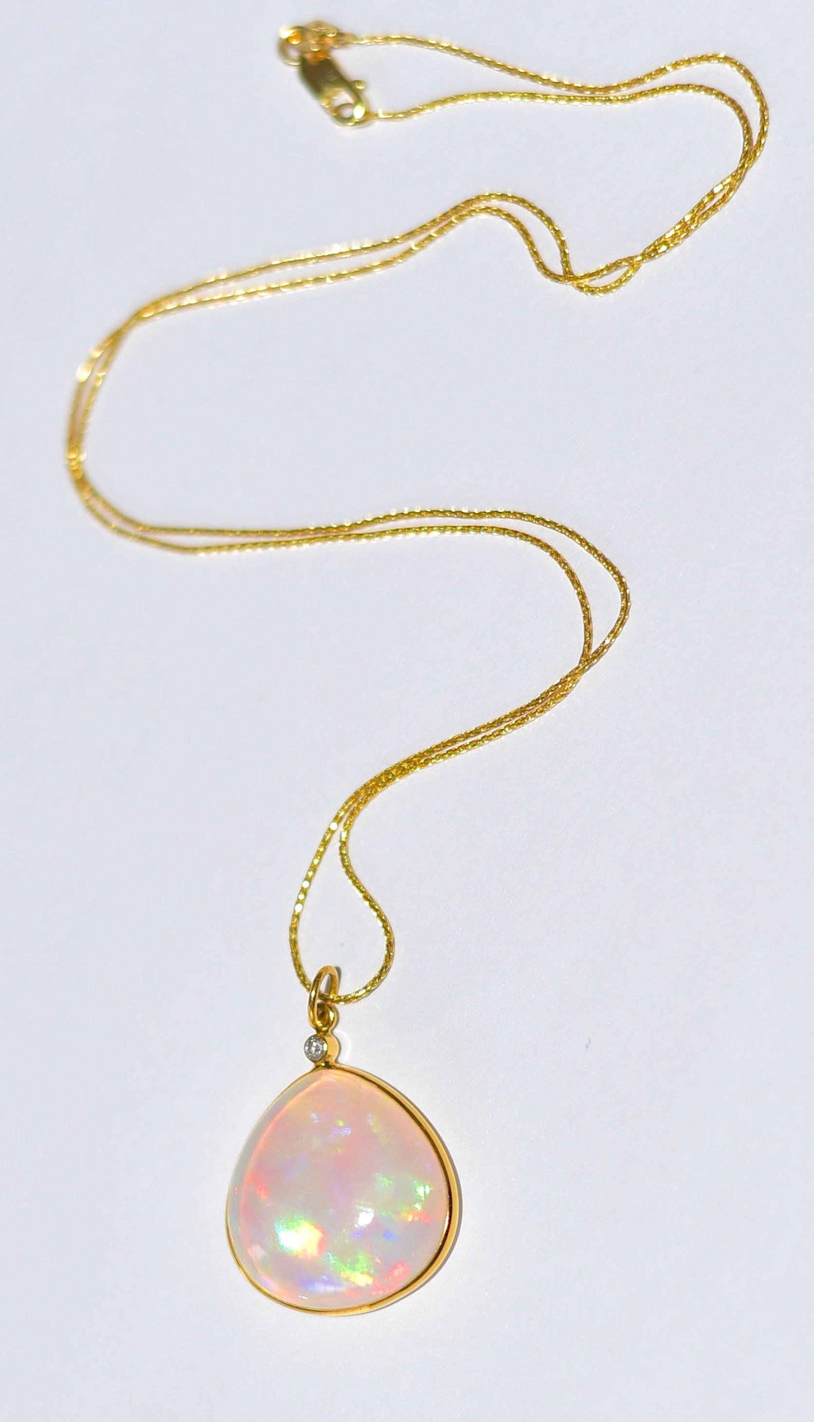 I ship all my products from the USA! 

Luxurious Natural Shimmering Opal (14 carat), 20X20 mm Opal Bezel plus 3mm hole. 
Special occasions or everyday wear! Full of play of color! Elegant. Luxurious. 
Chain: 14K solid yellow gold, Baby Wheat Spiga