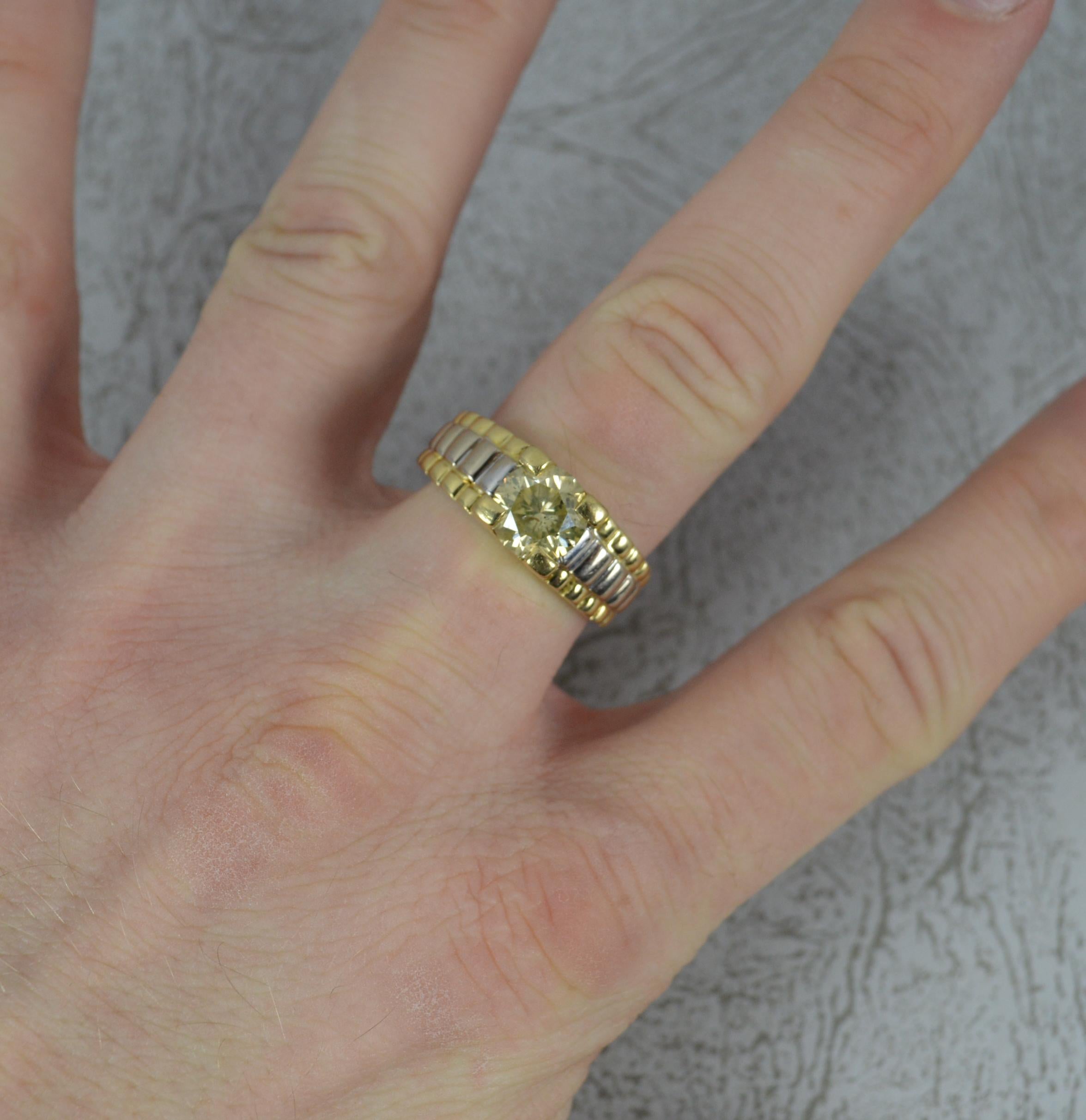 A superb 18ct gold and diamond ring.
Designed with a single natural, round brilliant cut diamond. 7.9mm diameter. 2 carats. Obvious natural, champagne colour.
Solid 18 carat yellow gold shank with white gold highlight. Based on the Rolex