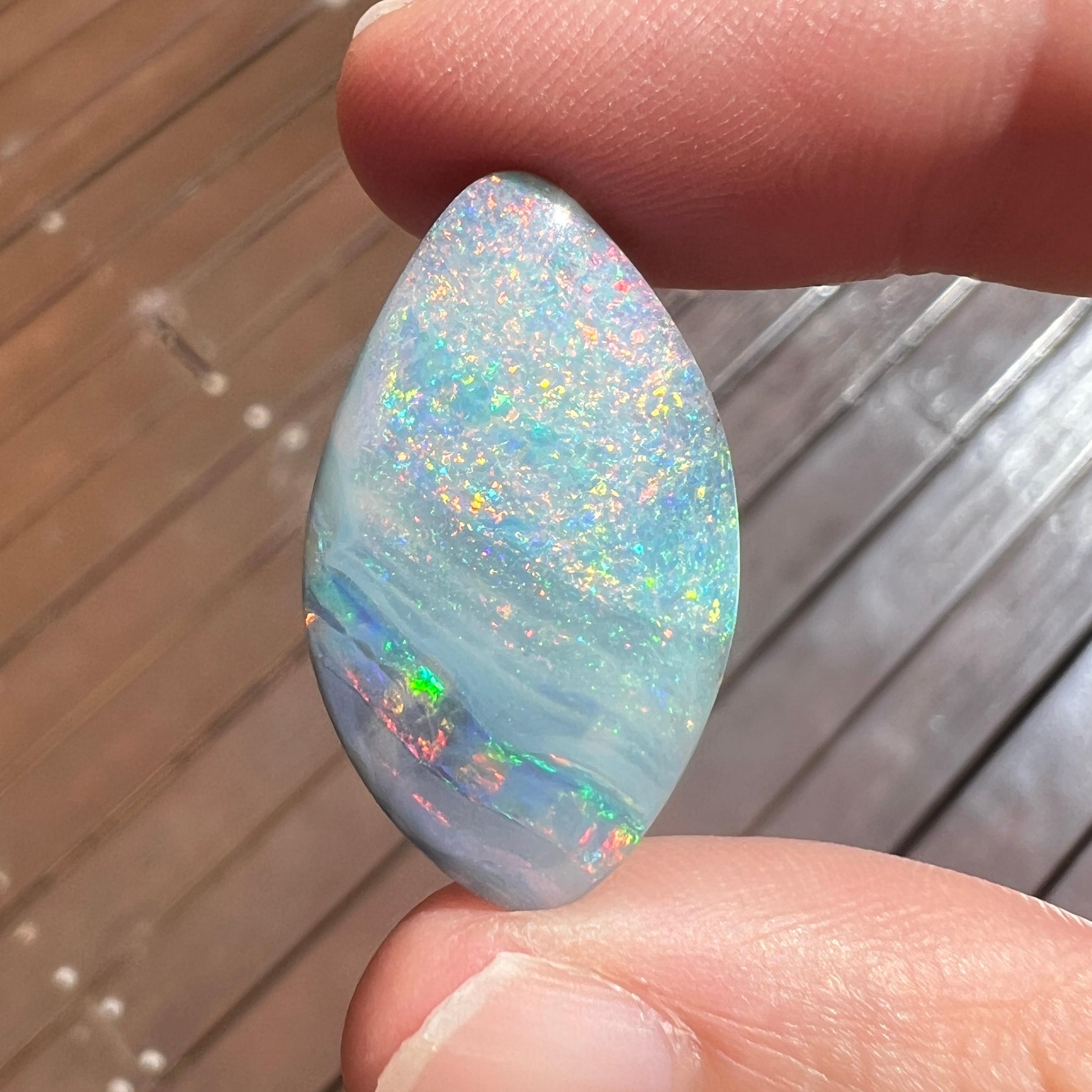 This beautiful 20.94 Ct Australian boulder opal was mined by Sue Cooper at her Russells opal mine in western Queensland, Australia in 2020. Sue processed the rough opal herself and cut into into a lovely balanced shape. 
We love how it has two