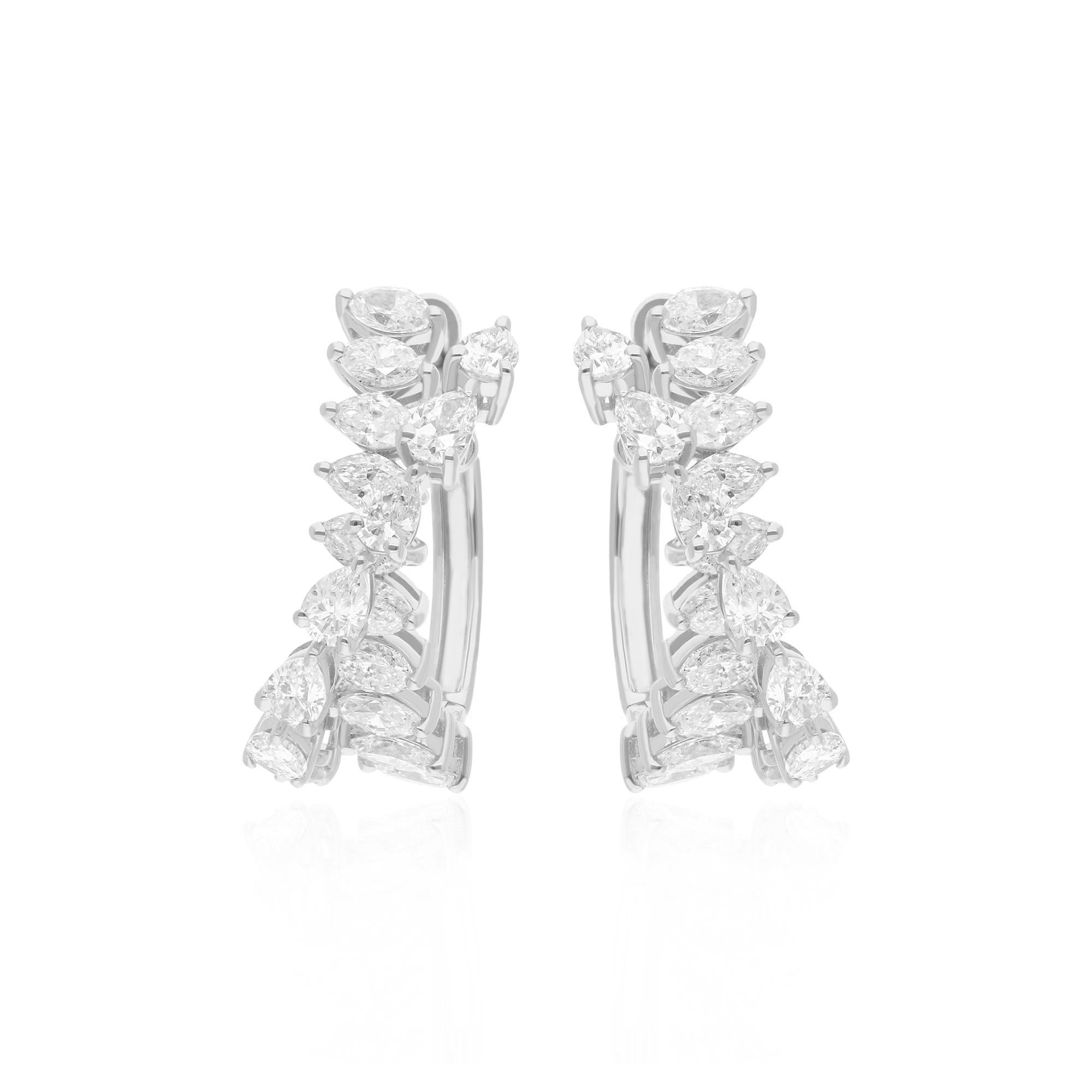 Crafted in lustrous 14 karat white gold, the metal serves as a perfect backdrop to the sparkling diamonds, creating a harmonious blend of precious materials. The smooth, polished finish of the white gold adds a touch of refinement to the earrings,