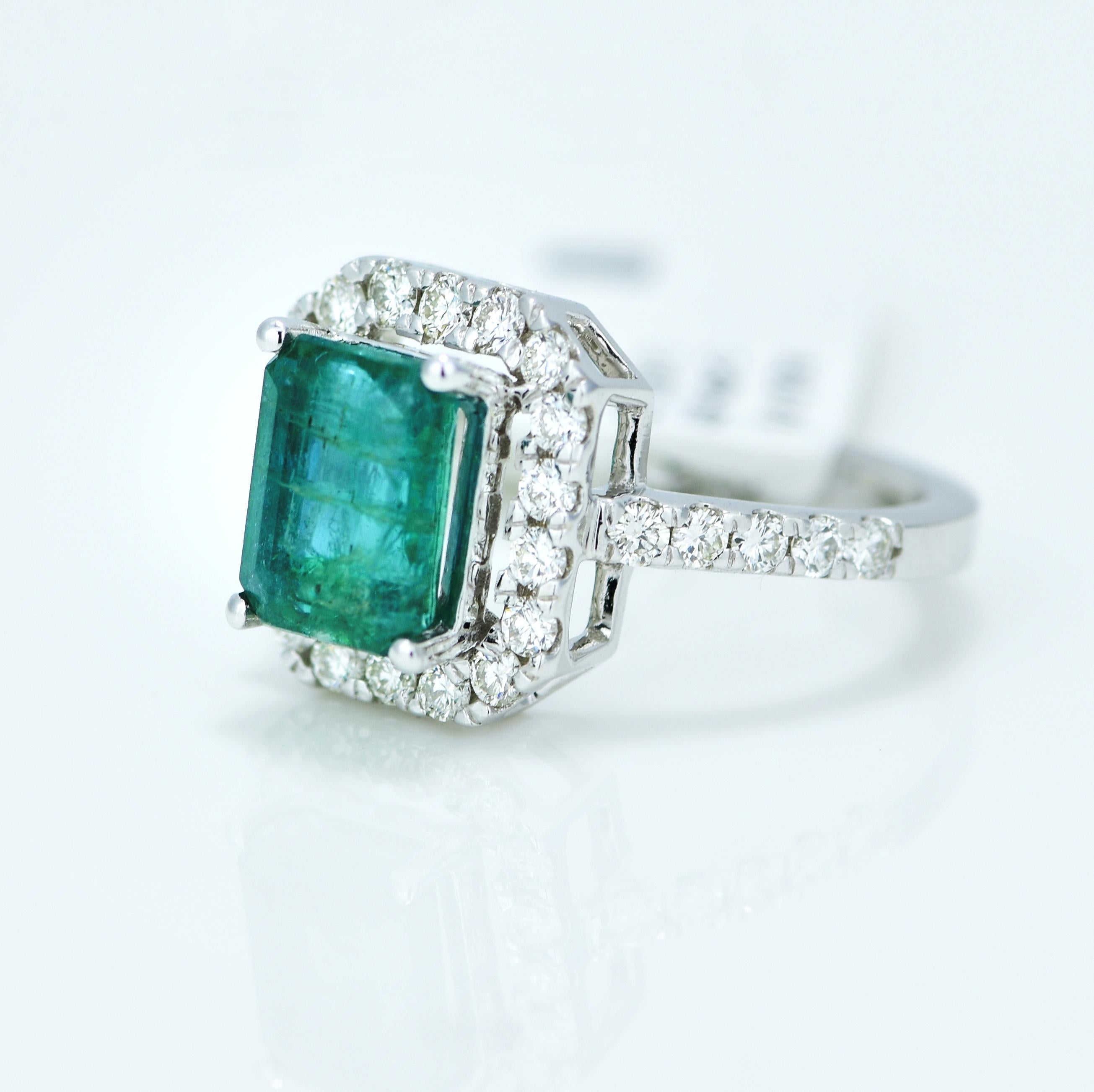 Stunning Green Emerald and Diamond Halo Ring.

Centre Stone - Natural Green Emerald

Centre Stone Shape - Cut Cornered Rectangular

Centre Stone Weight - 2.11 Carat, 

Centre Stone Origin - Zambian (Minor Oil)

Total Number of Diamonds -