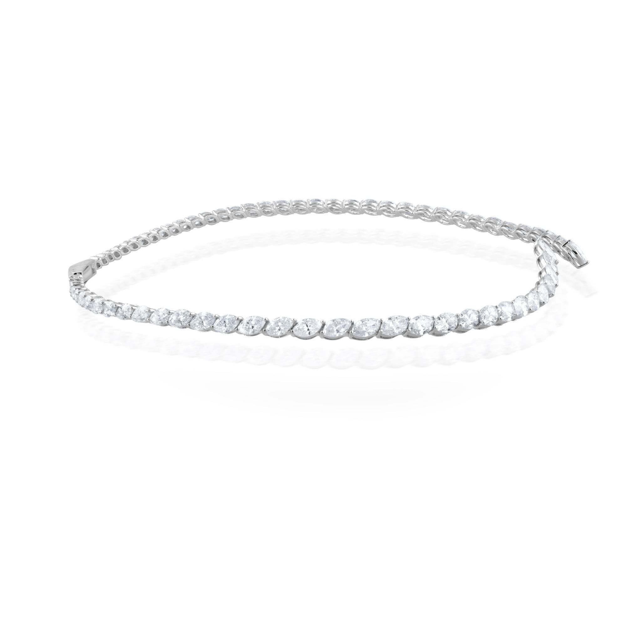 Fashioned from 18 karat white gold, this necklace exudes a timeless allure, its lustrous metal providing the perfect complement to the magnificent marquise diamonds that adorn it. Each diamond is a marvel of nature, meticulously chosen for its