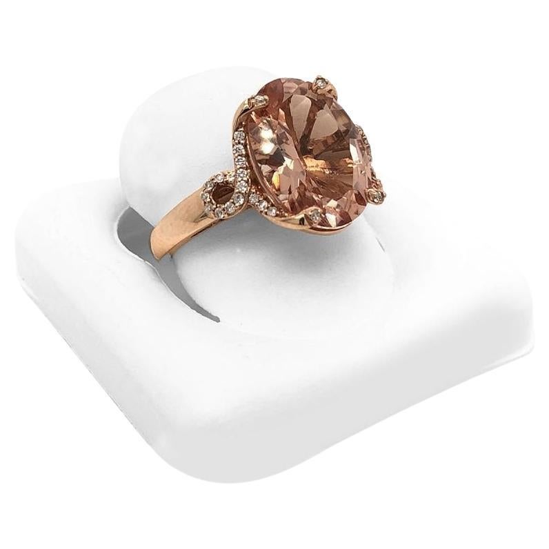 This is a marvelous natural morganite and diamond ring set in solid 14K rose gold. The stunning natural oval 2.51 Ct Morganite has an excellent peachy pink color ring set on top of a gorgeous diamond accented shank. The ring is stamped in 14K rose