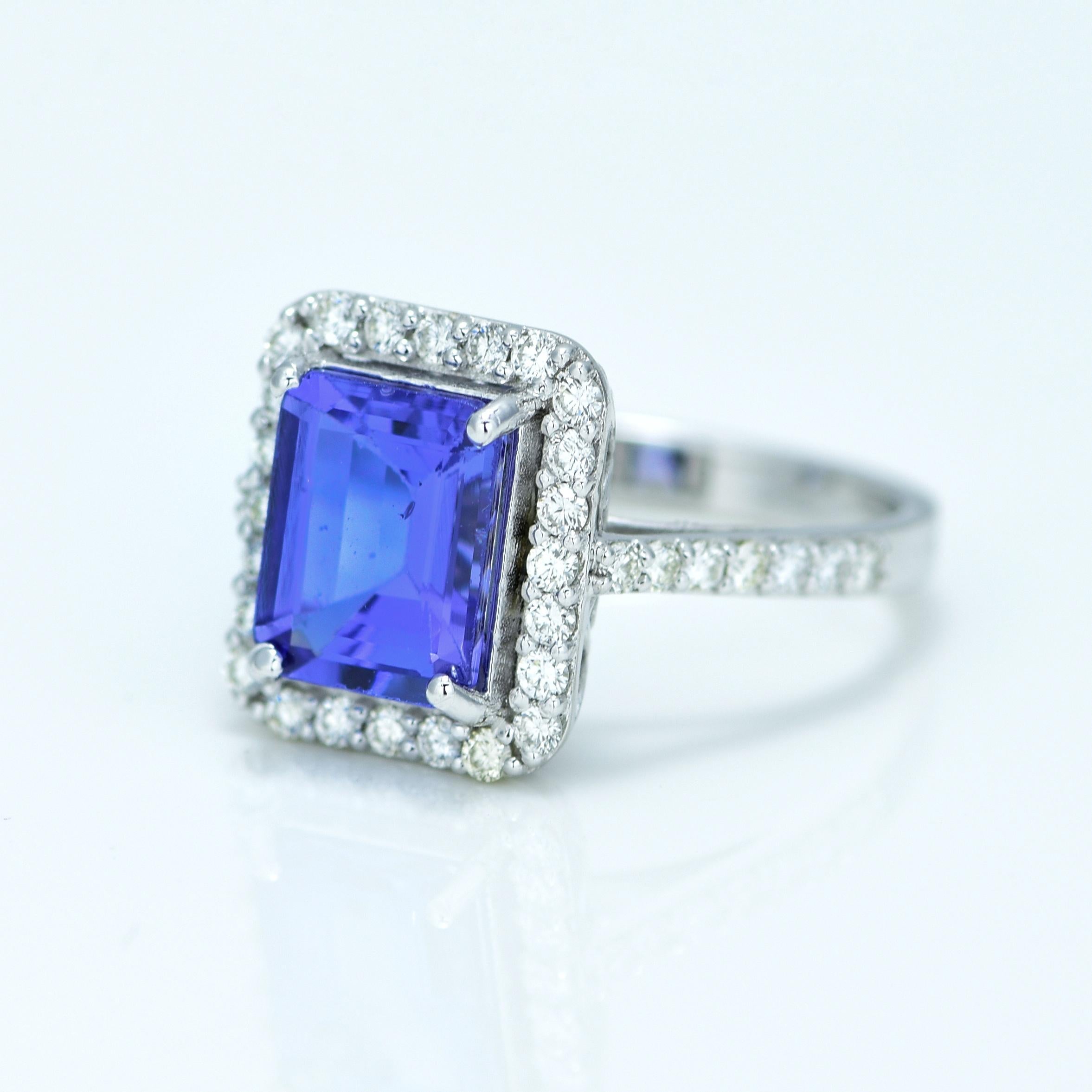 Stunning Violetish Blue Tanzanite and Diamond halo ring.

Centre Stone - Natural Tanzanite, 
Centre Stone Weight - 2.60 Carat, 
Centre Stone Shape & Cut - Rectangular Step Cut
 
Total Number of Diamonds - 52, 
Diamonds Carat Weight - 0.54