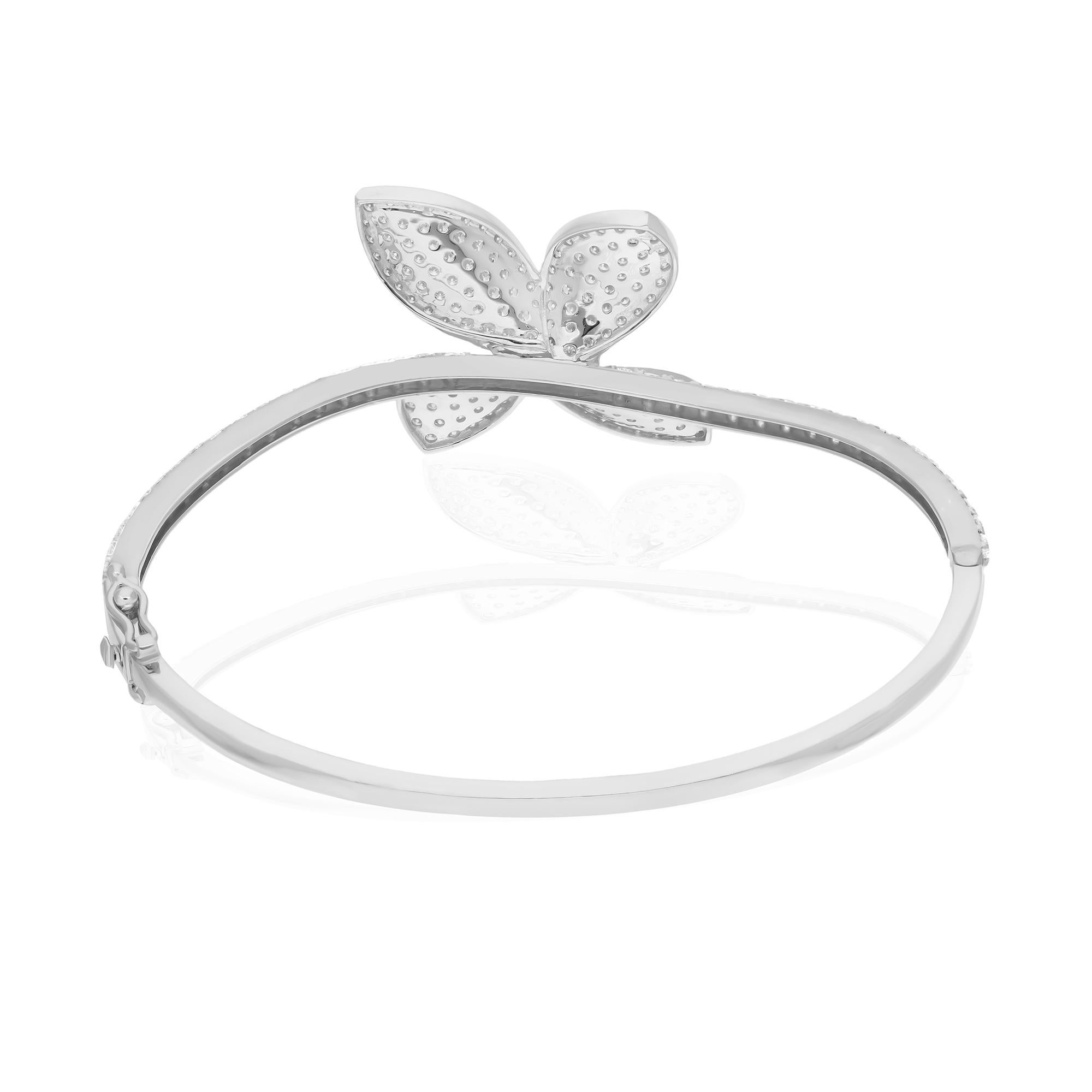 Add a touch of ethereal elegance to your jewelry collection with this stunning Natural 2.65 Carat SI/HI Diamond Butterfly Bangle Bracelet. Crafted from luxurious 18 Karat White Gold, this bracelet embodies sophistication and timeless beauty, making