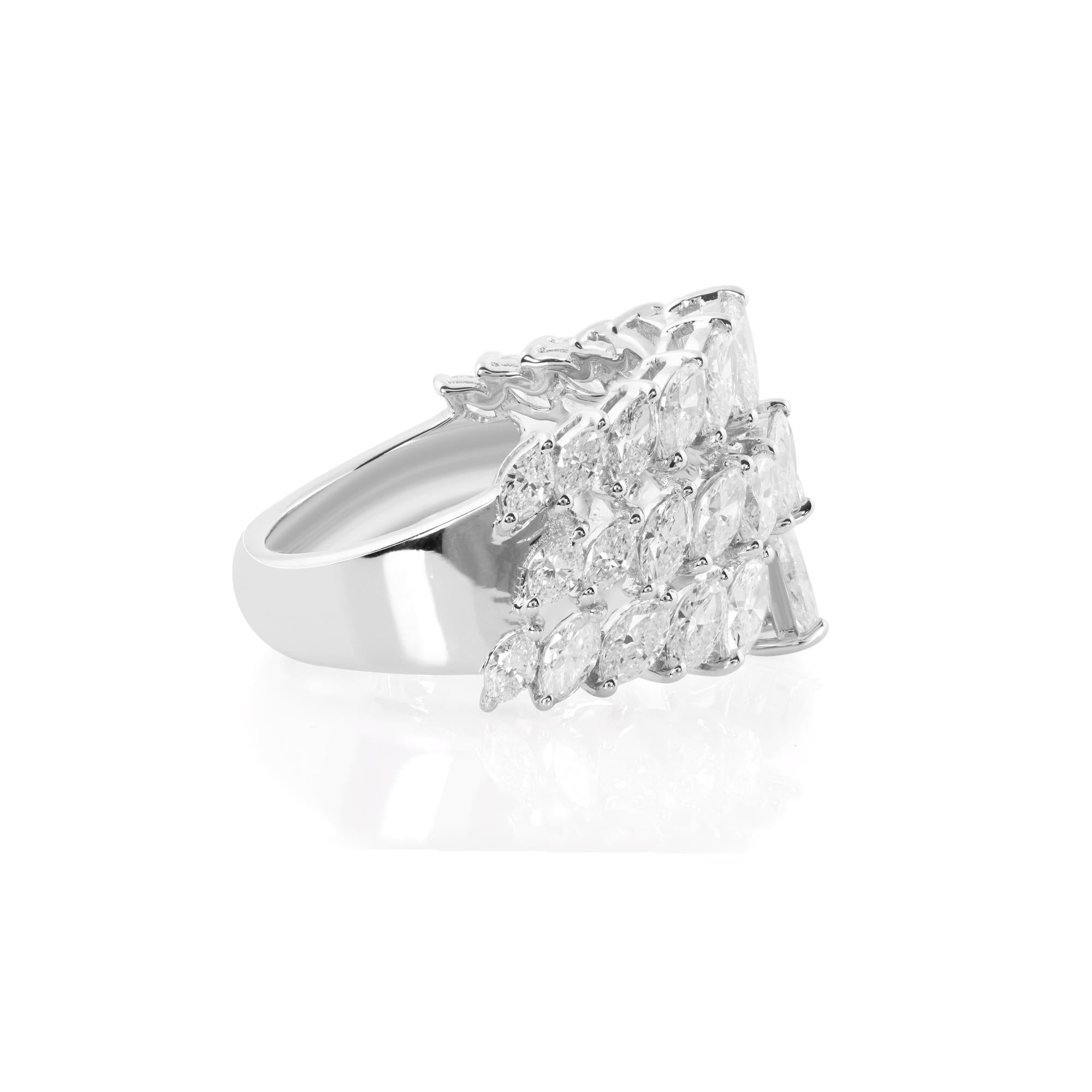 At the heart of this stunning cuff ring lies a magnificent 2.77 carat marquise-cut diamond, expertly chosen for its exceptional brilliance and captivating beauty. The marquise cut, with its elongated shape and gracefully tapered ends, exudes a sense