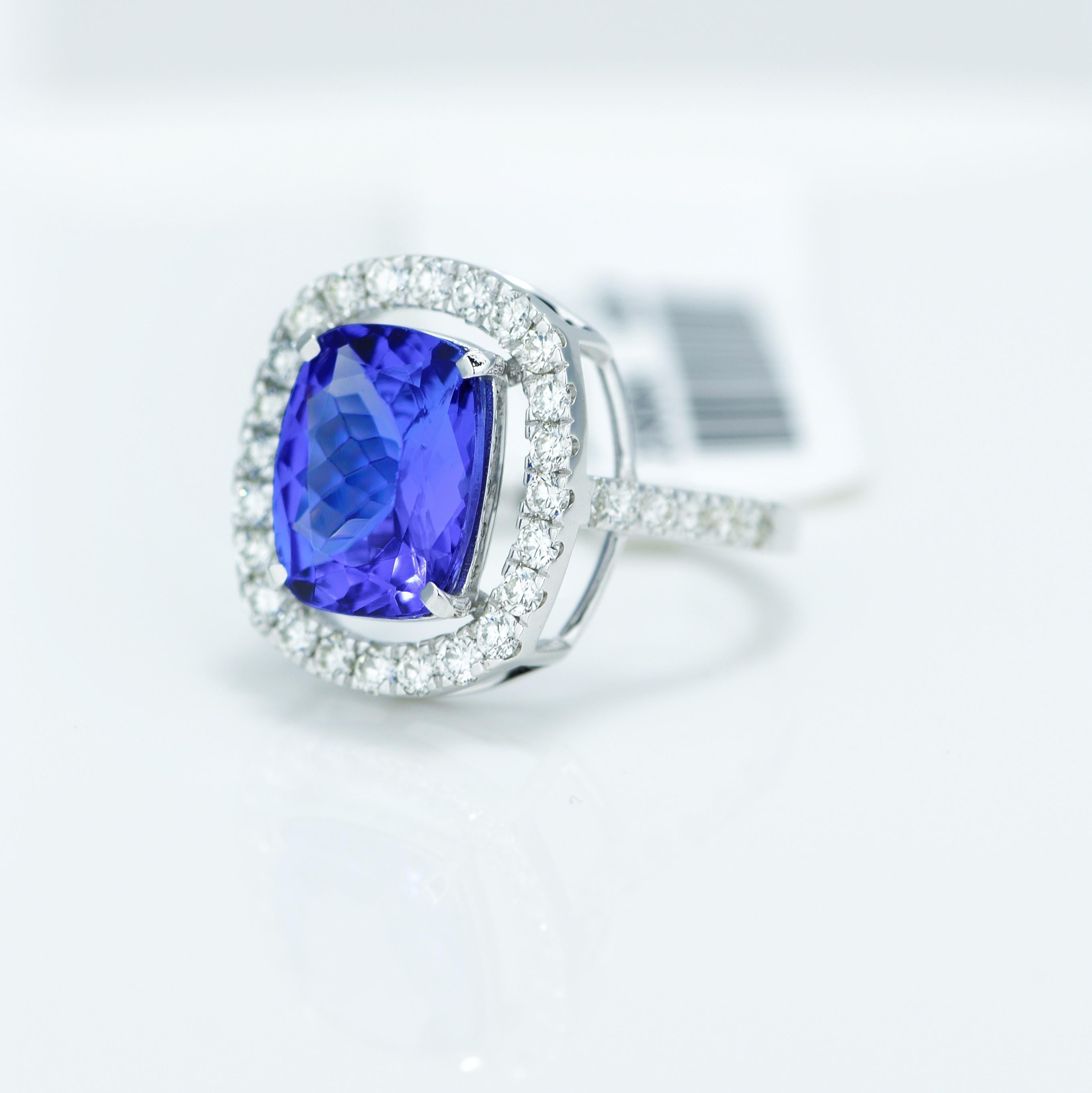 Stunning Violetish Blue Tanzanite and Diamond halo ring.

Centre Stone - Natural Tanzanite, 
Centre Stone Weight - 2.80 Carat, 
Centre Stone Shape & Cut - Cushion Step Cut
 
Total Number of Diamonds - 34, 
Diamonds Carat Weight - 0.58 carat
Diamond