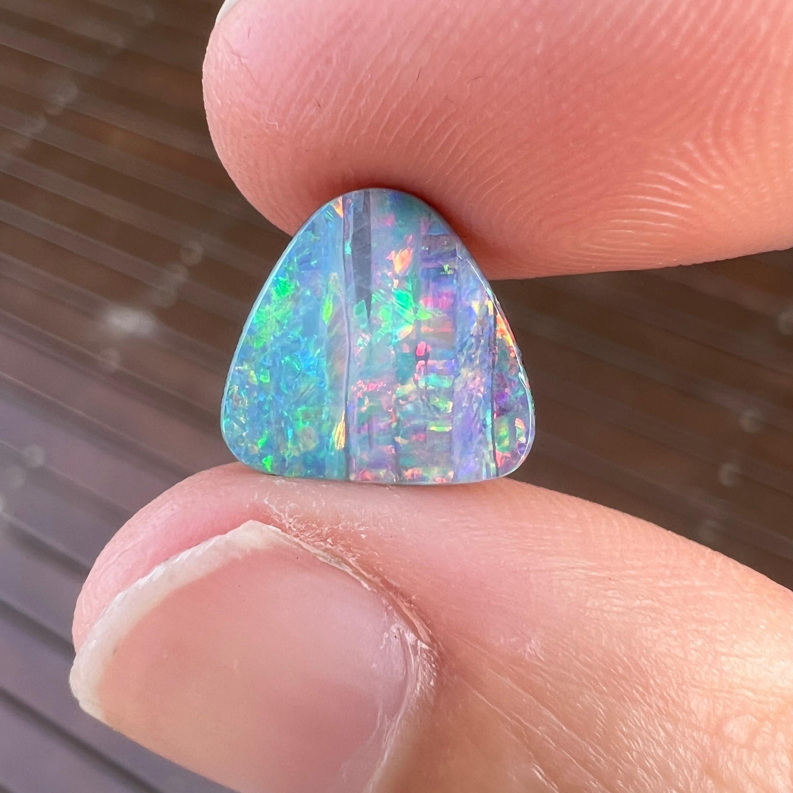 This gorgeous 2.85 Ct Australian boulder opal was mined by Sue Cooper at her Yaraka opal mine in western Queensland, Australia in 2022. Sue processed the rough opal herself and cut into a triangle shape with soft corners shape. We especially love