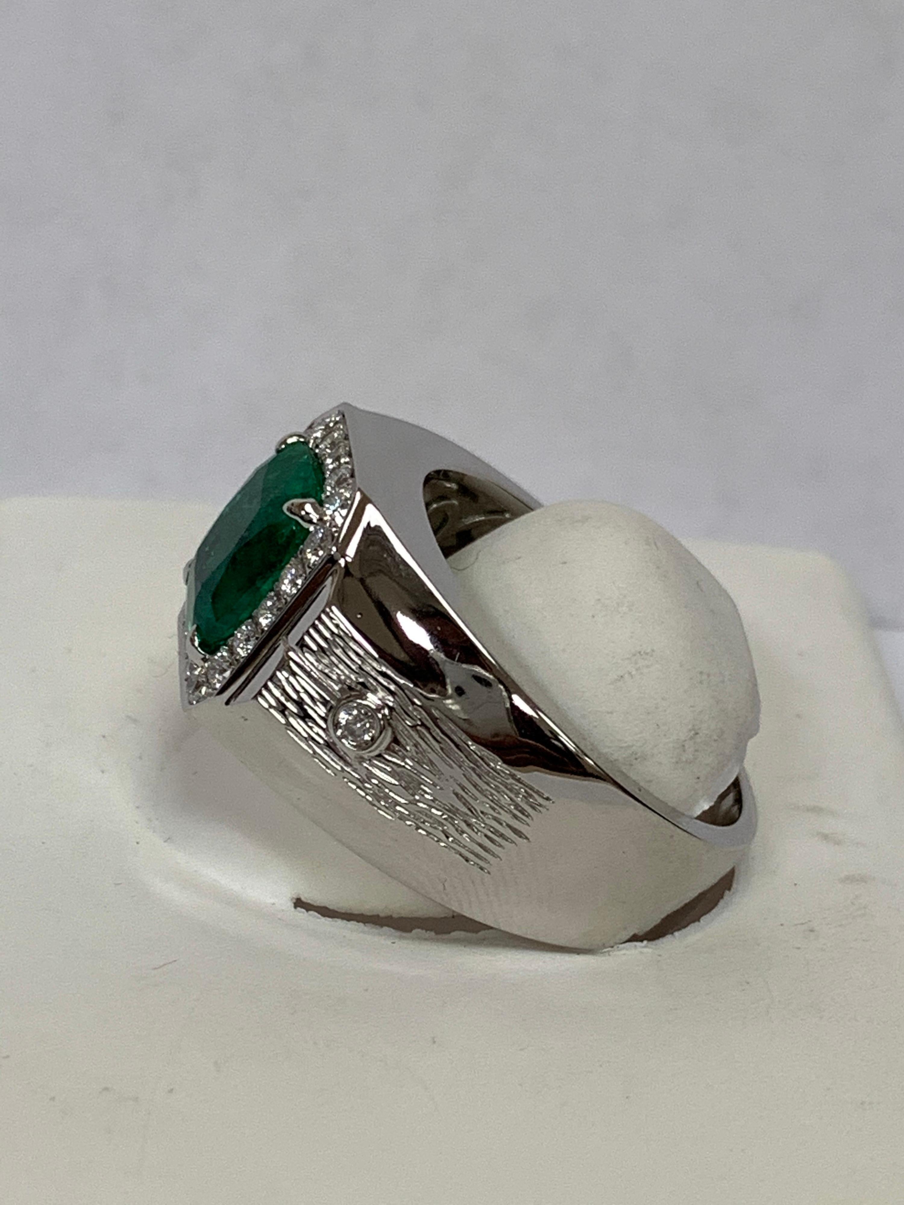 Natural 3.00 Carat emerald with 0.42 Carat diamonds accents set in 14 Karat white gold, solid mounting is one of a kind hand crafted ring . The Ring  size is 12  and can be resized if needed.
