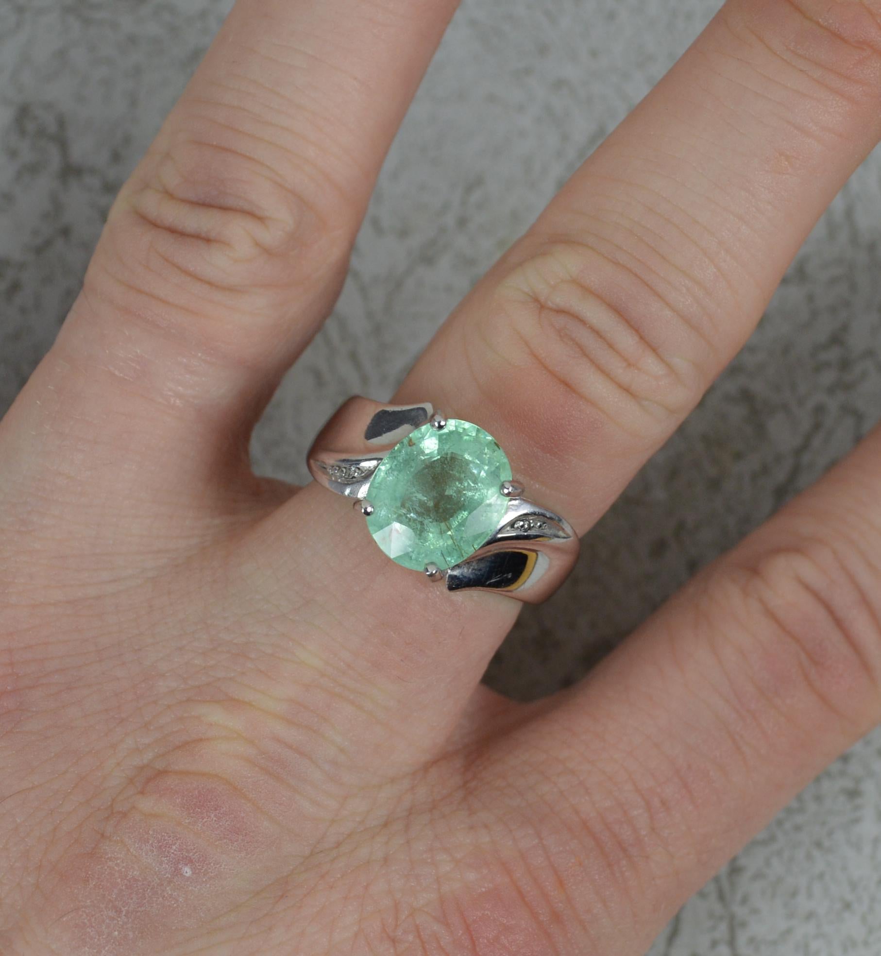 A superb tourmaline and diamond ring.
Solid 18 carat white gold example.
Designed with an oval cut paraiba tourmaline to the centre. 8mm x 11mm, approx 3 carats. To each side is a small round cut diamond.
A natural tourmaline, untreated.
CONDITION ;