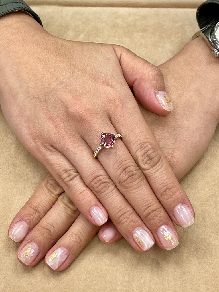 Here is a wonderful peach pink Spinel cocktail ring. The ring is set in 18k rose gold and diamonds. There are 0.18 Cts total of small round diamonds on each shank of the ring. The Natural Spinel is well cut. The color is crispy. The ring is full of